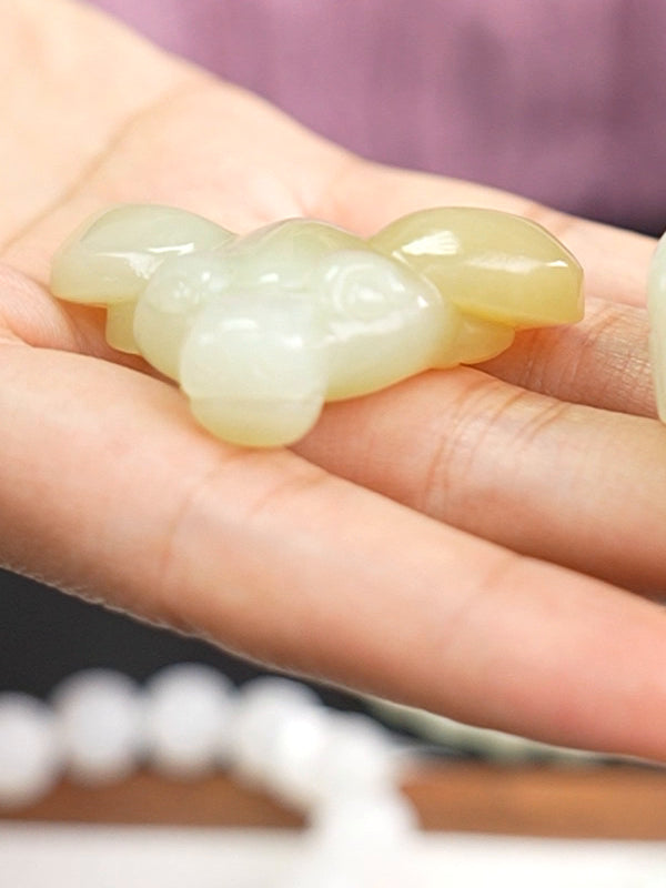 Hetian nephrite jade carved pendant B12609024905, hand-held view 1; pale pendant beside it is not included