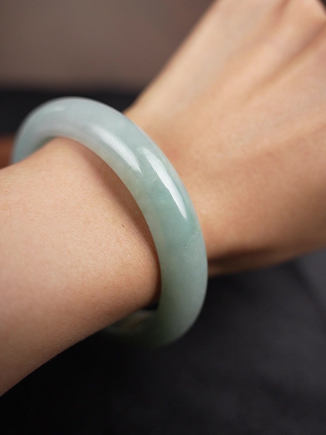 Pale green Type A jadeite bangle worn on wrist, angle 3
