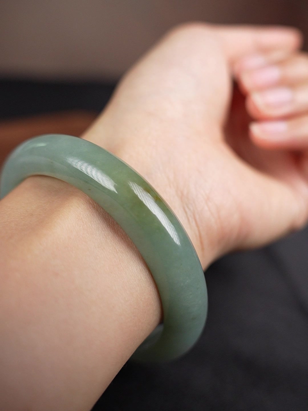 Pale green Type A jadeite bangle worn on wrist, angle 5