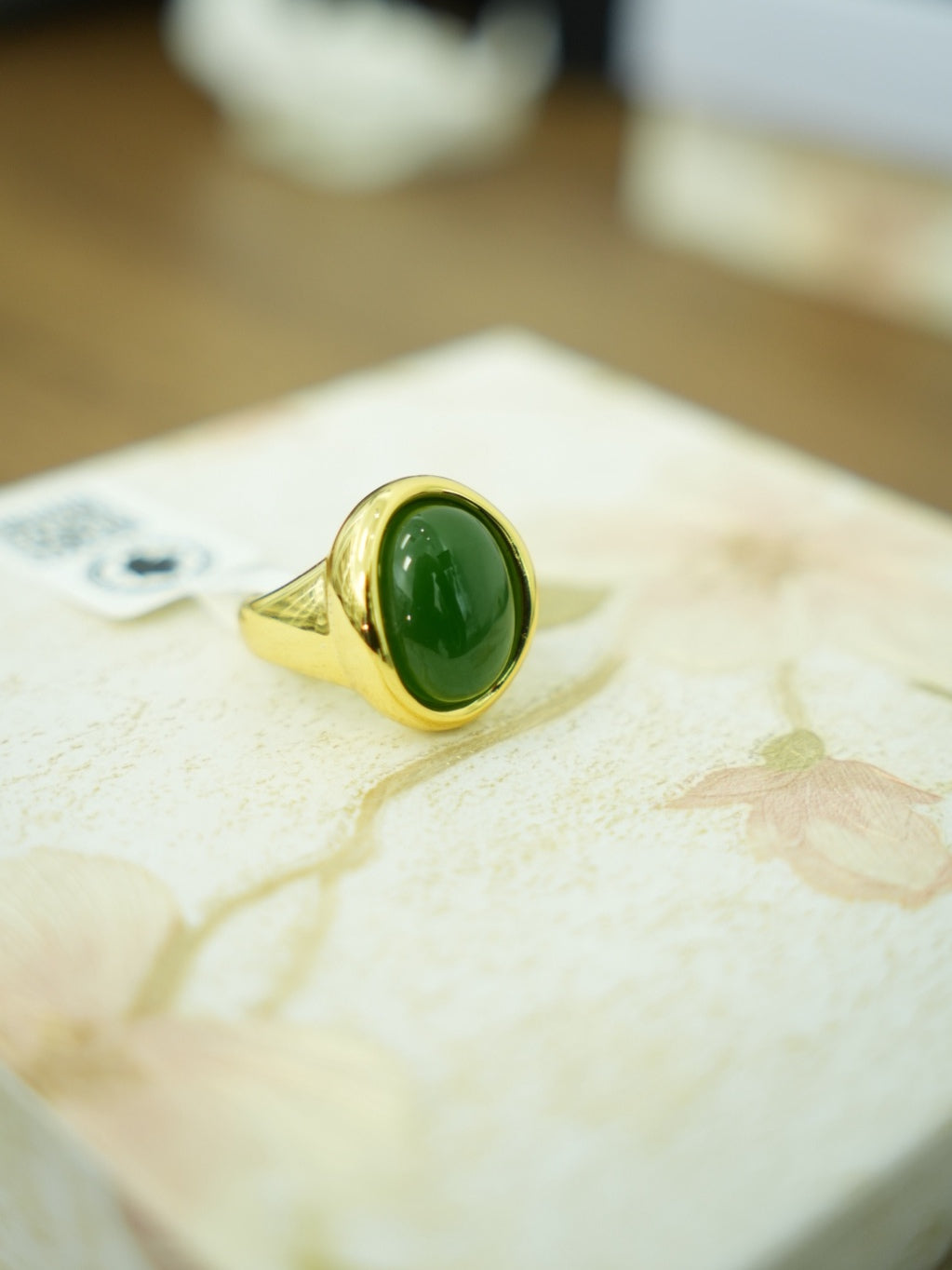 Green Hetian nephrite jade ring in a silver setting with a gold-tone appearance