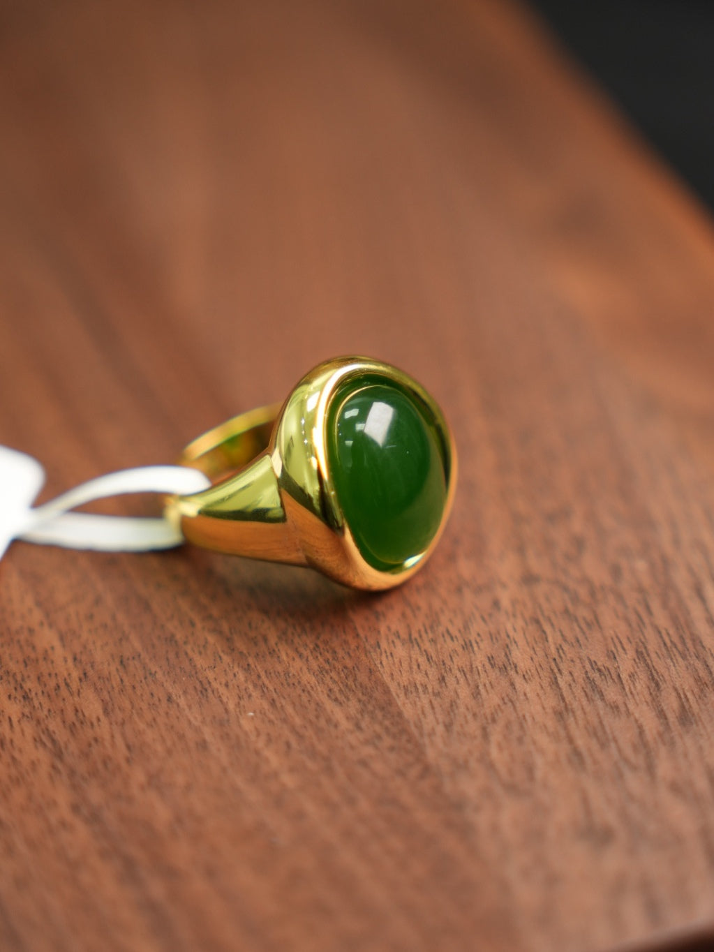 Green Hetian nephrite jade ring in a silver setting with a gold-tone appearance