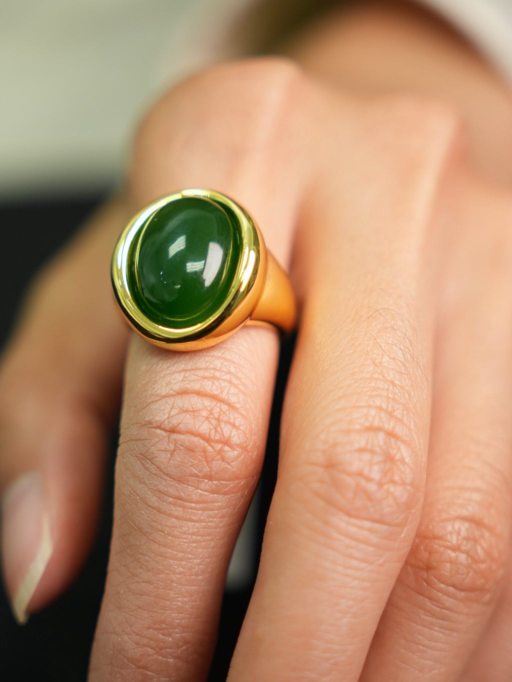 Green Hetian nephrite jade ring in a silver setting with a gold-tone appearance