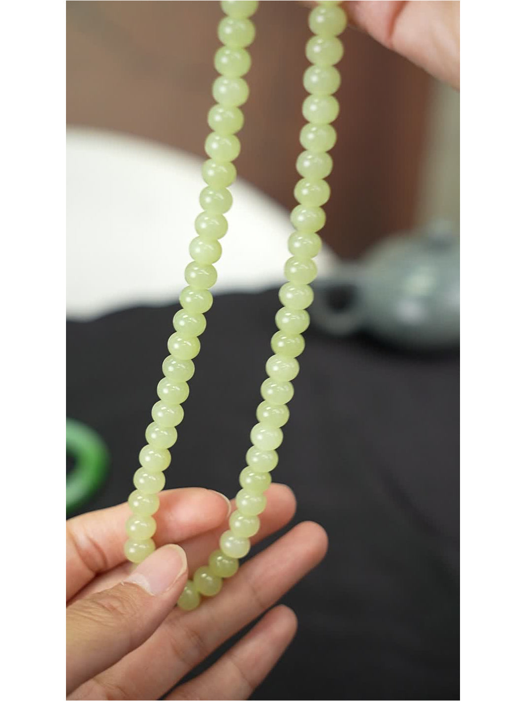 Yellow-green Huangkou Hetian nephrite jade bead necklace held in hand, actual piece 2026-100205