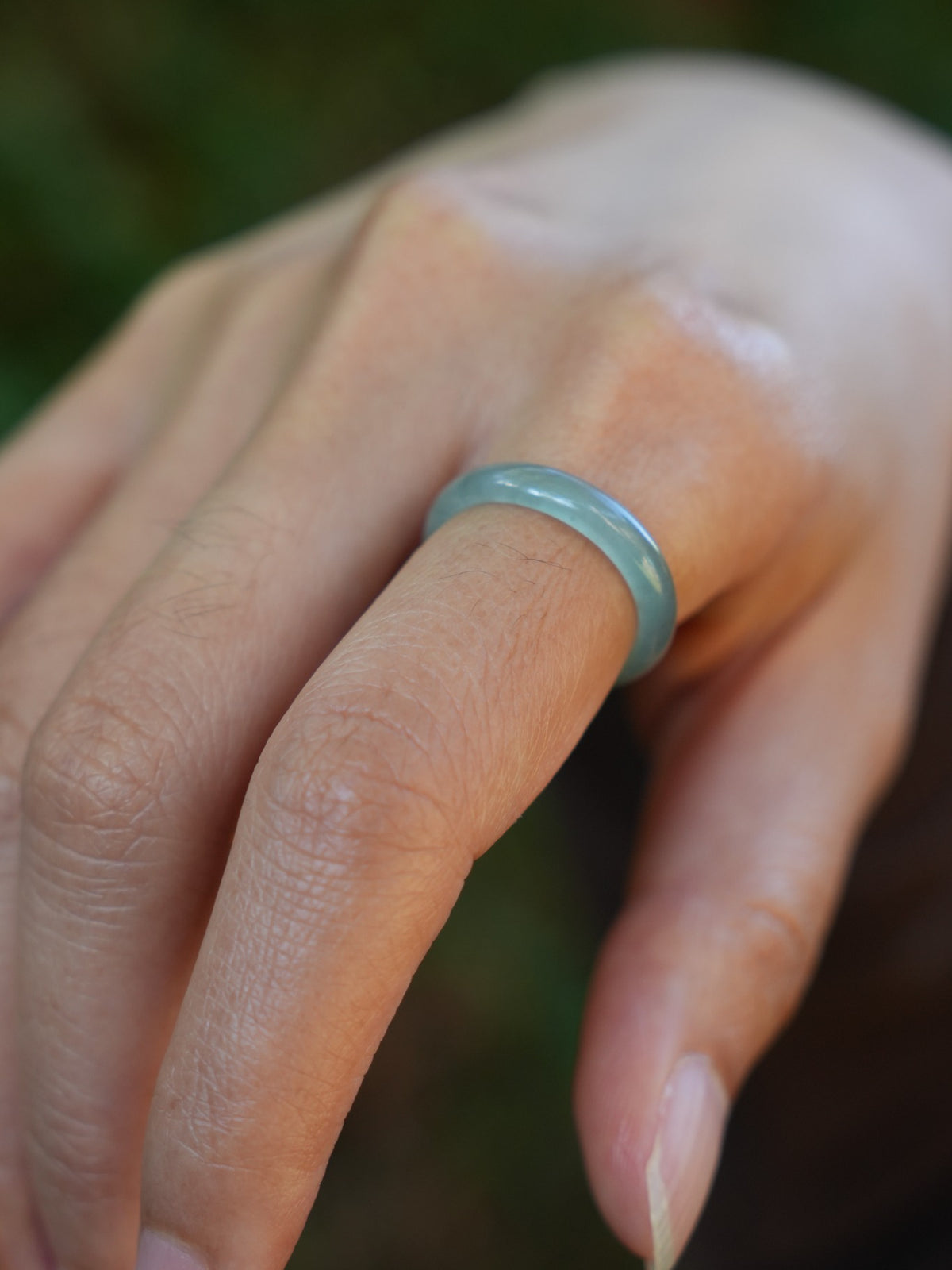 Green jadeite band rings — worn on hand, detail and styling view
