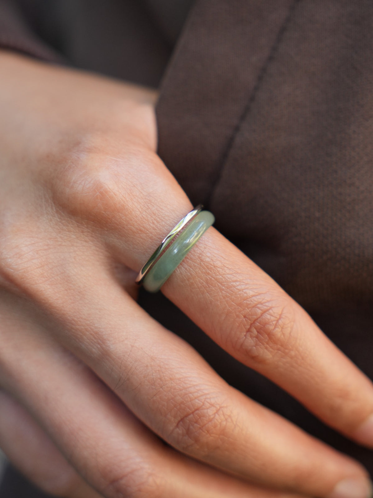 Green jadeite band rings — worn on hand, detail and styling view