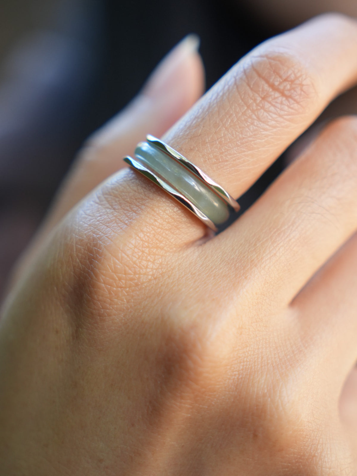 Green jadeite band rings — worn on hand, detail and styling view