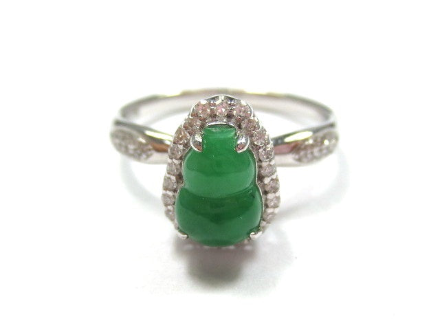Green carved jadeite ring with a scalloped silhouette and sparkling halo