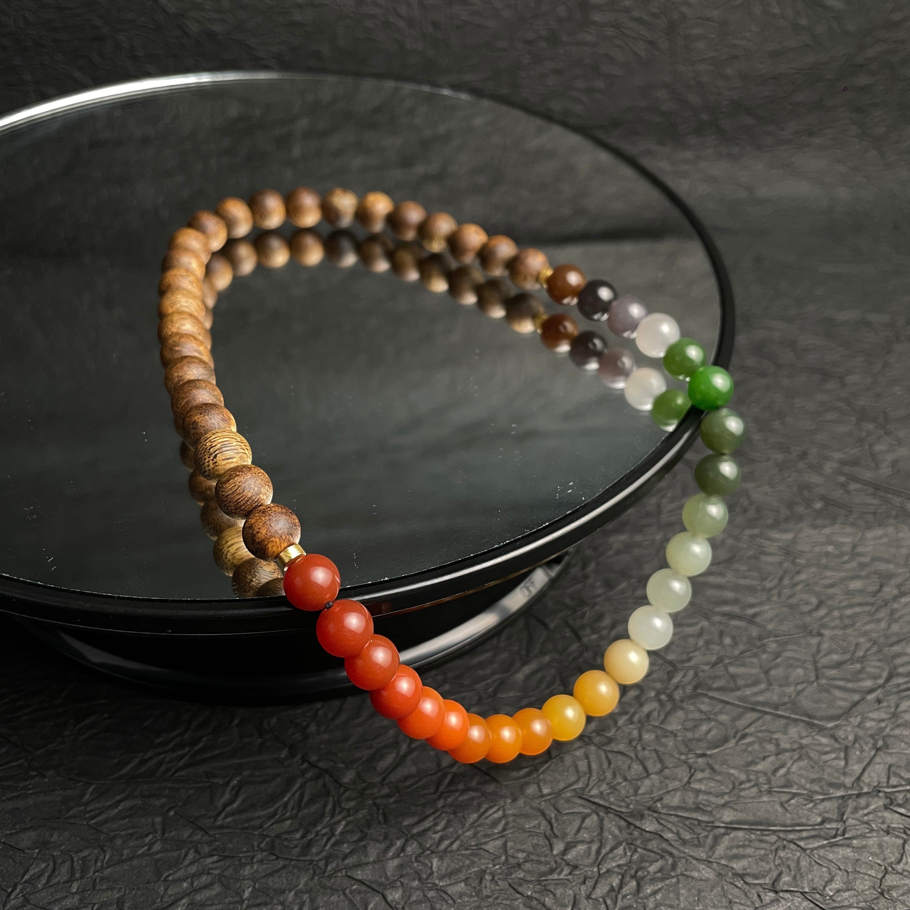Sylvia Jewelry multi-wrap bracelet featuring natural agarwood beads and a gradient of multi-colored Hetian nephrite jade.