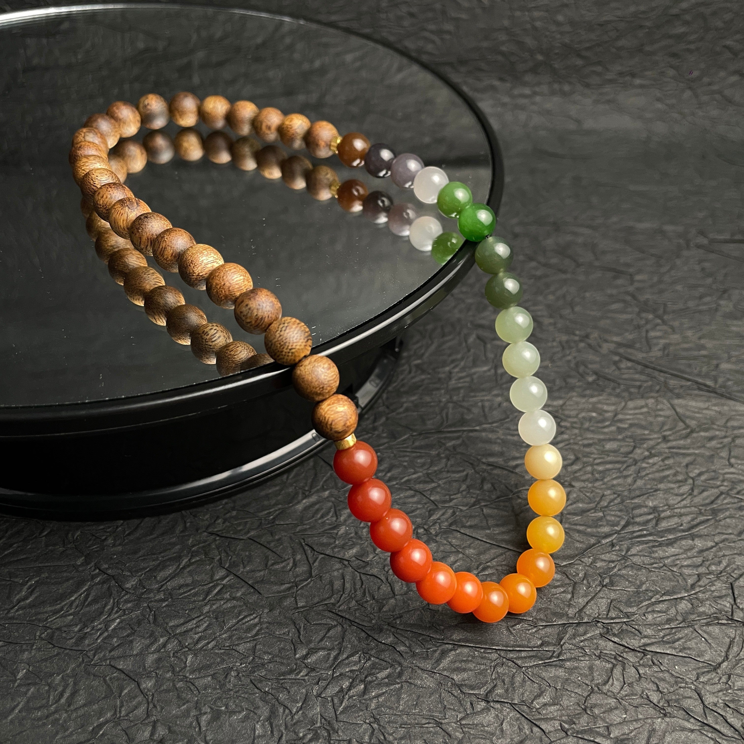 Sylvia Jewelry multi-wrap bracelet featuring natural agarwood beads and a gradient of multi-colored Hetian nephrite jade.