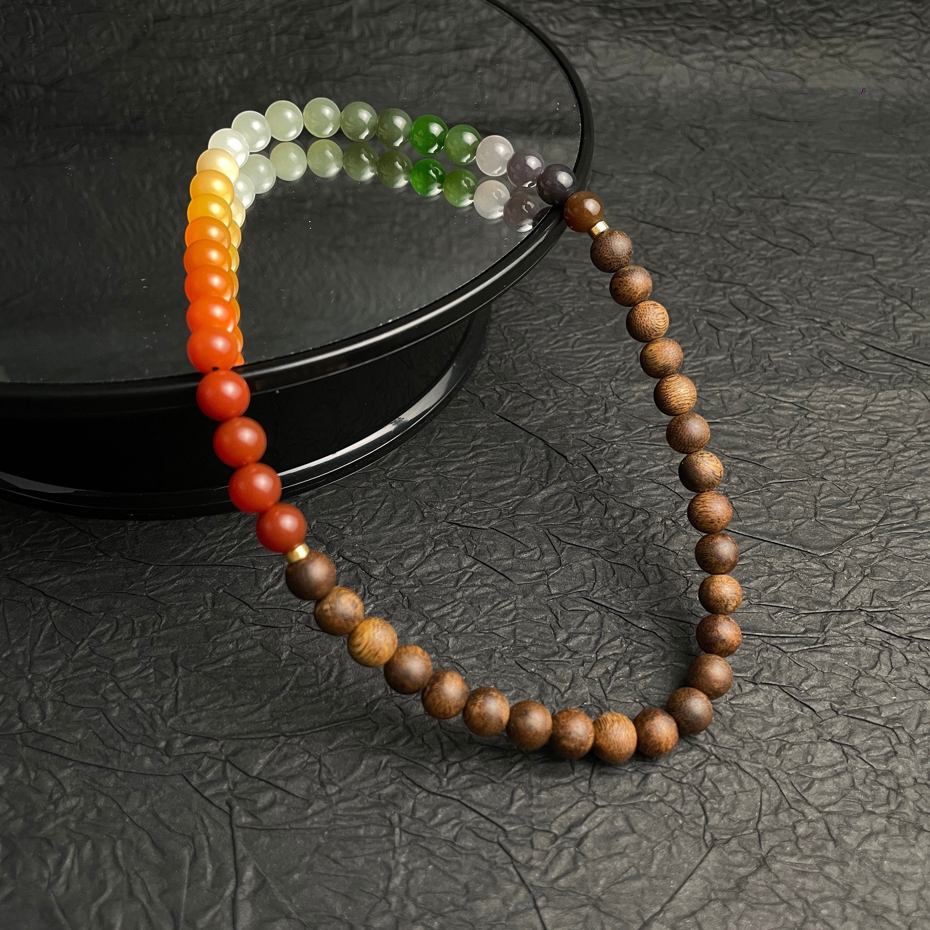 Sylvia Jewelry multi-wrap bracelet featuring natural agarwood beads and a gradient of multi-colored Hetian nephrite jade.