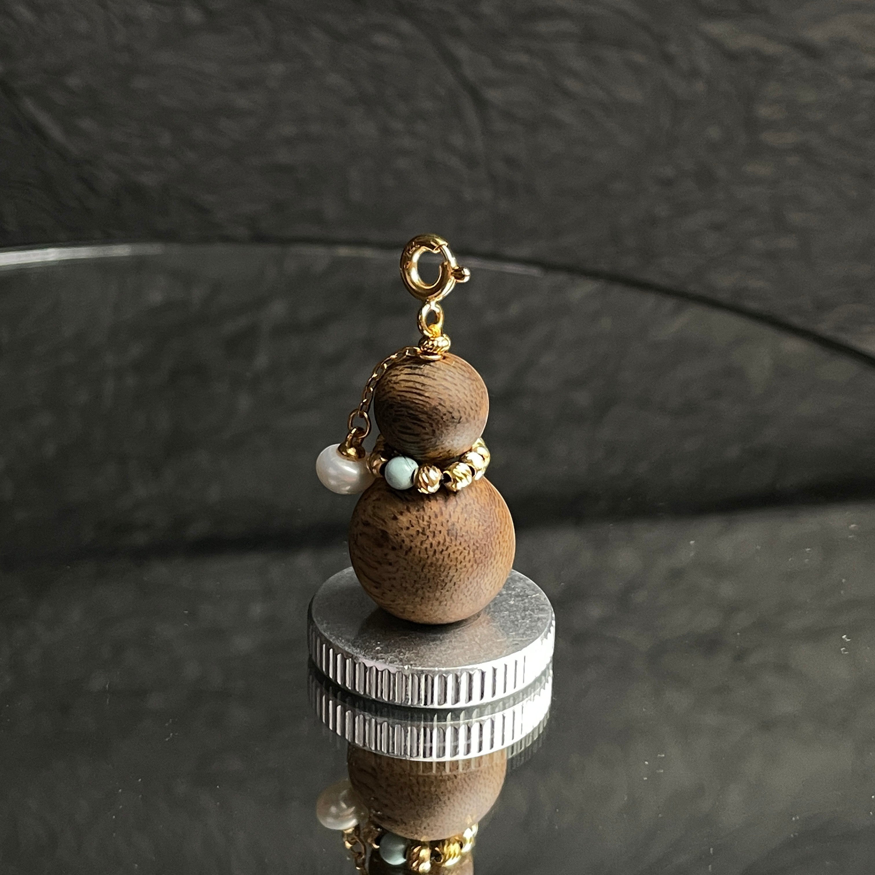 Sylvia Jewelry aromatic agarwood Wu Lou charm with turquoise bead, freshwater pearl, and gold-plated clasp.