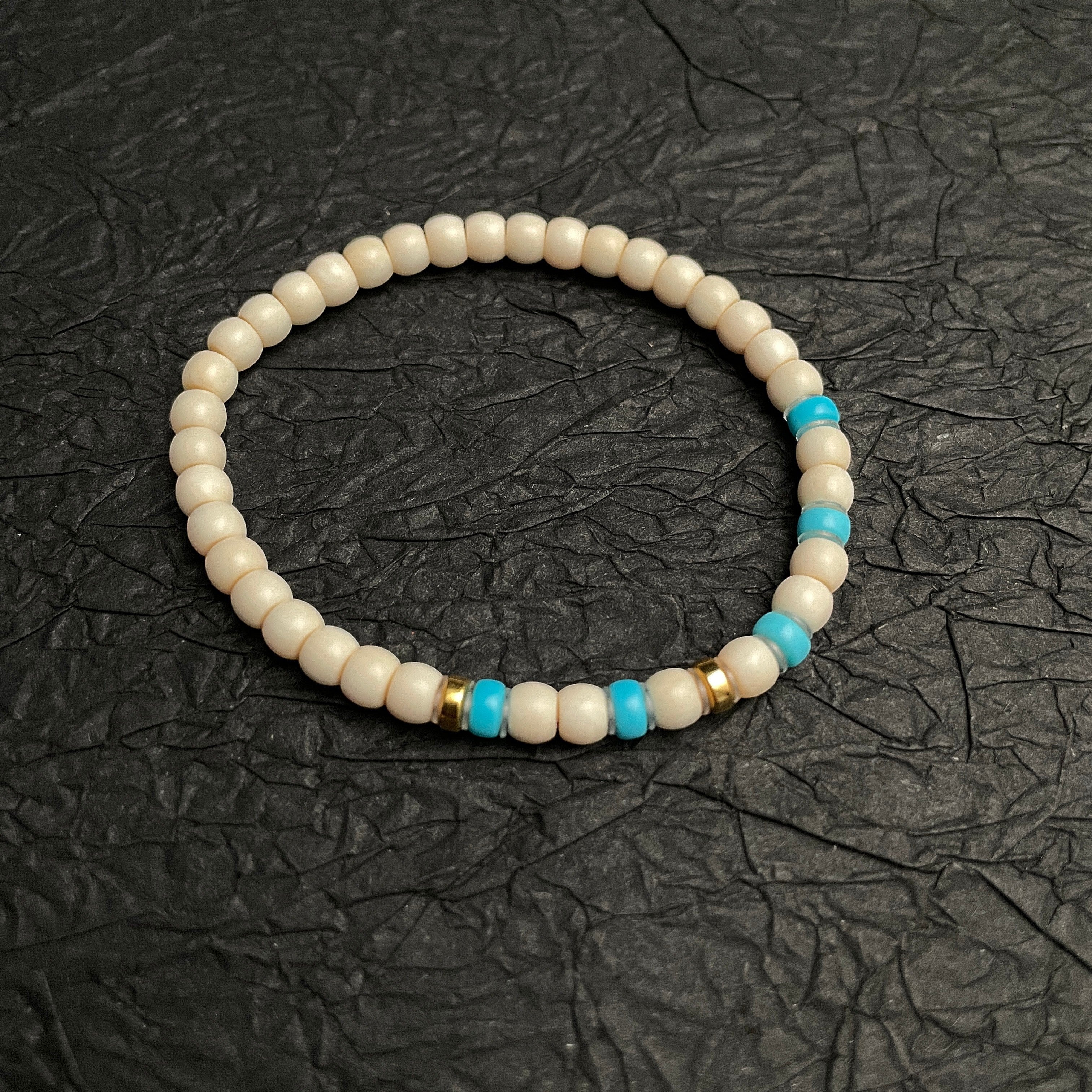 Sylvia Jewelry cream-colored beaded bracelet with turquoise accents and gold spacers, ideal for casual wear.