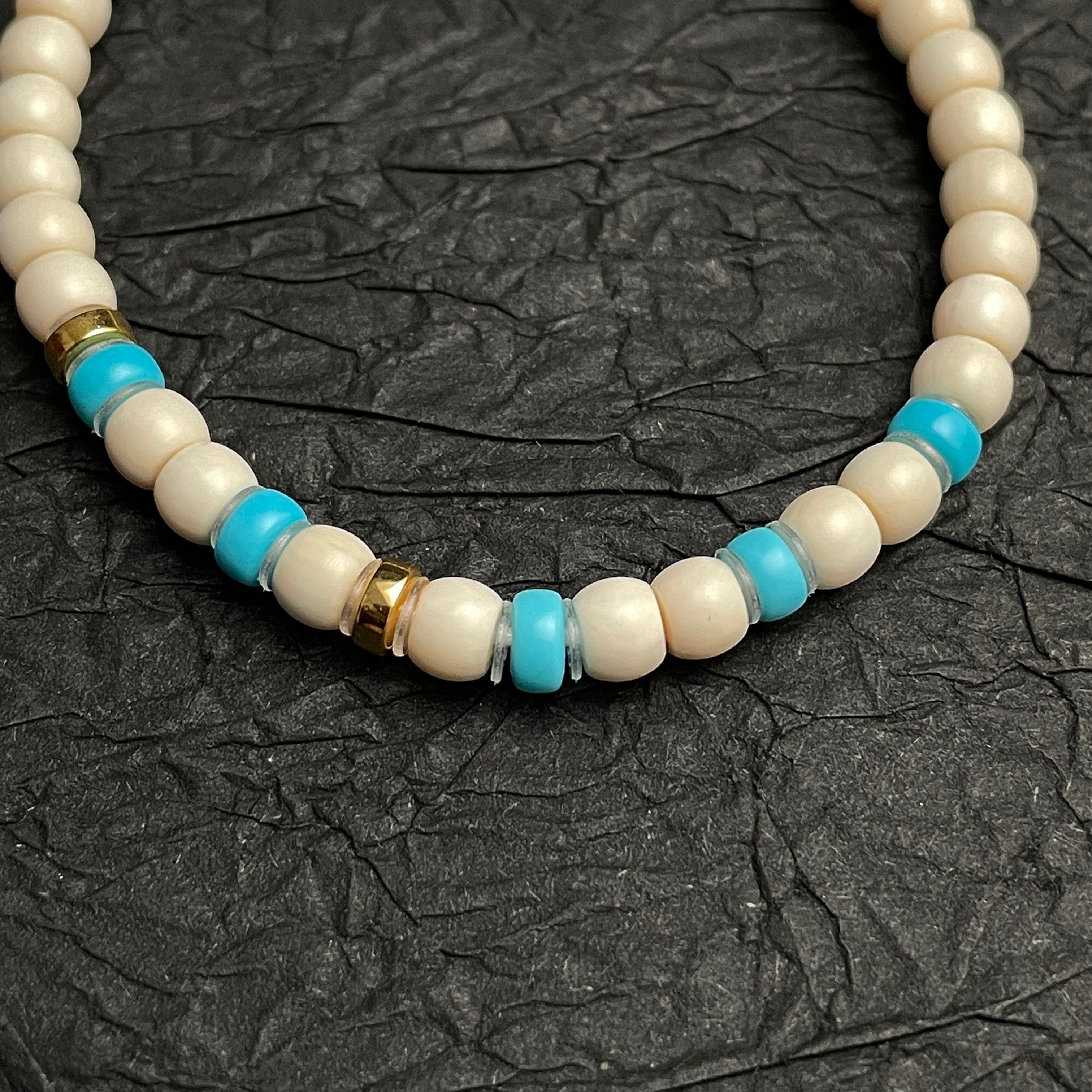 Sylvia Jewelry cream-colored beaded bracelet with turquoise accents and gold spacers, designed for daily wear.