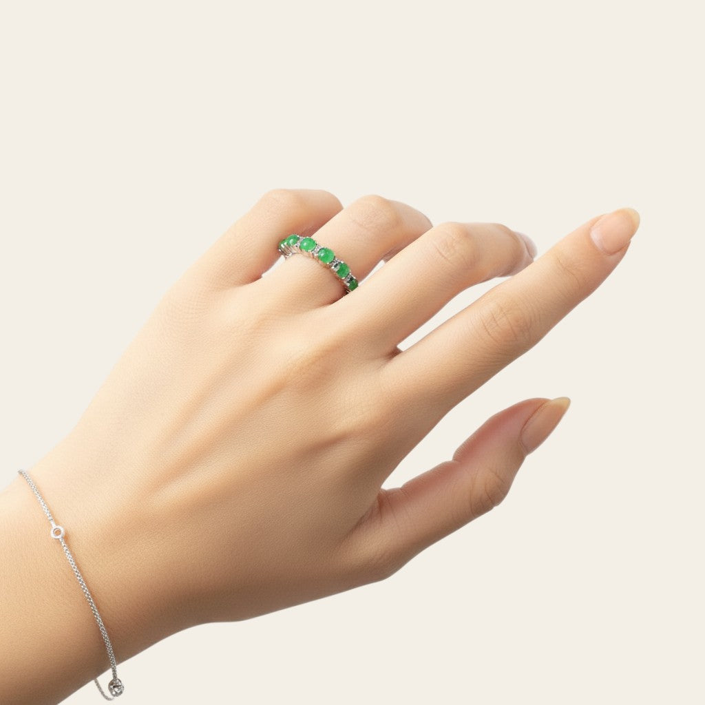 Sylvia Jewelry ring featuring a row of small green jade cabochons set in silver on a woman's finger