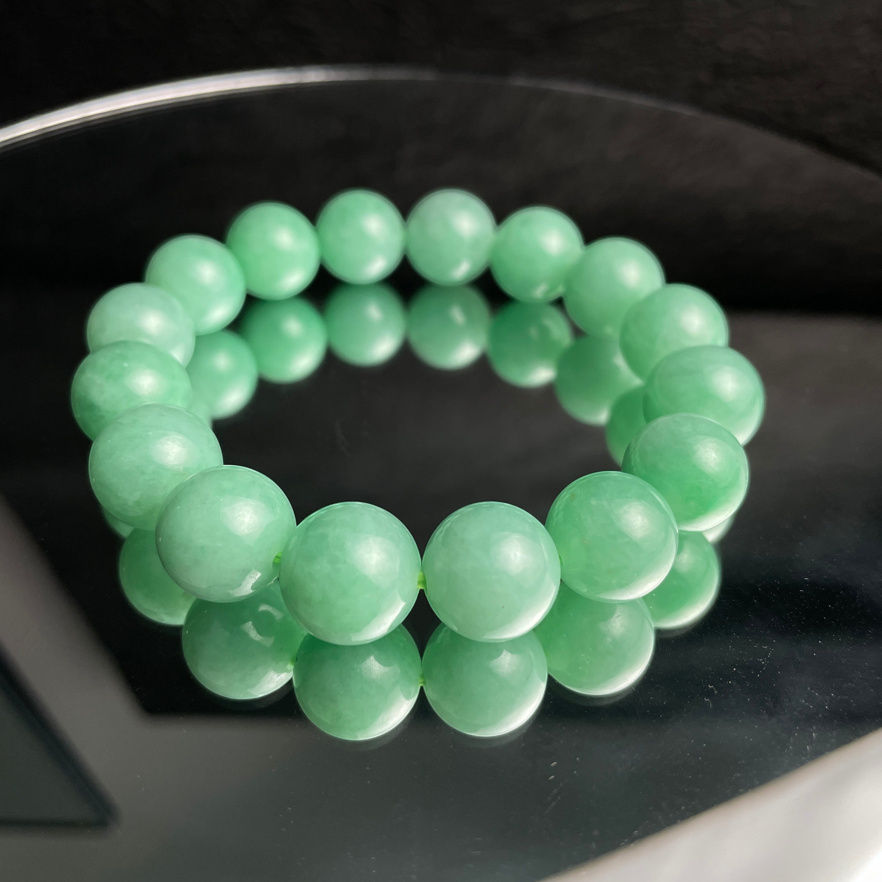 Sylvia Jewelry 14mm smooth green jadeite bead bracelet with natural luster, ideal for daily wear.