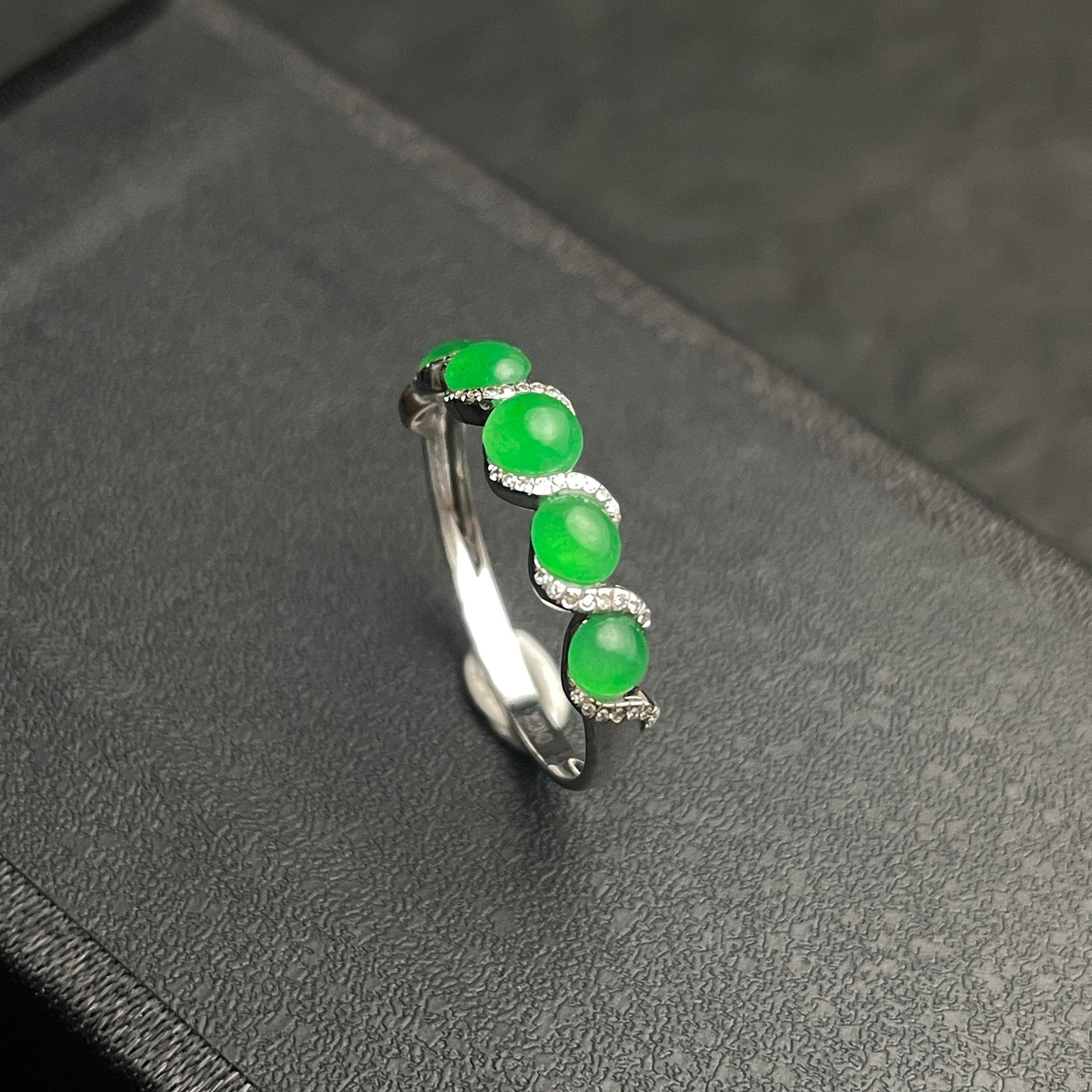 Sylvia Jewelry five-stone apple green jadeite ring in 18k white gold with diamond-encrusted wave design.
