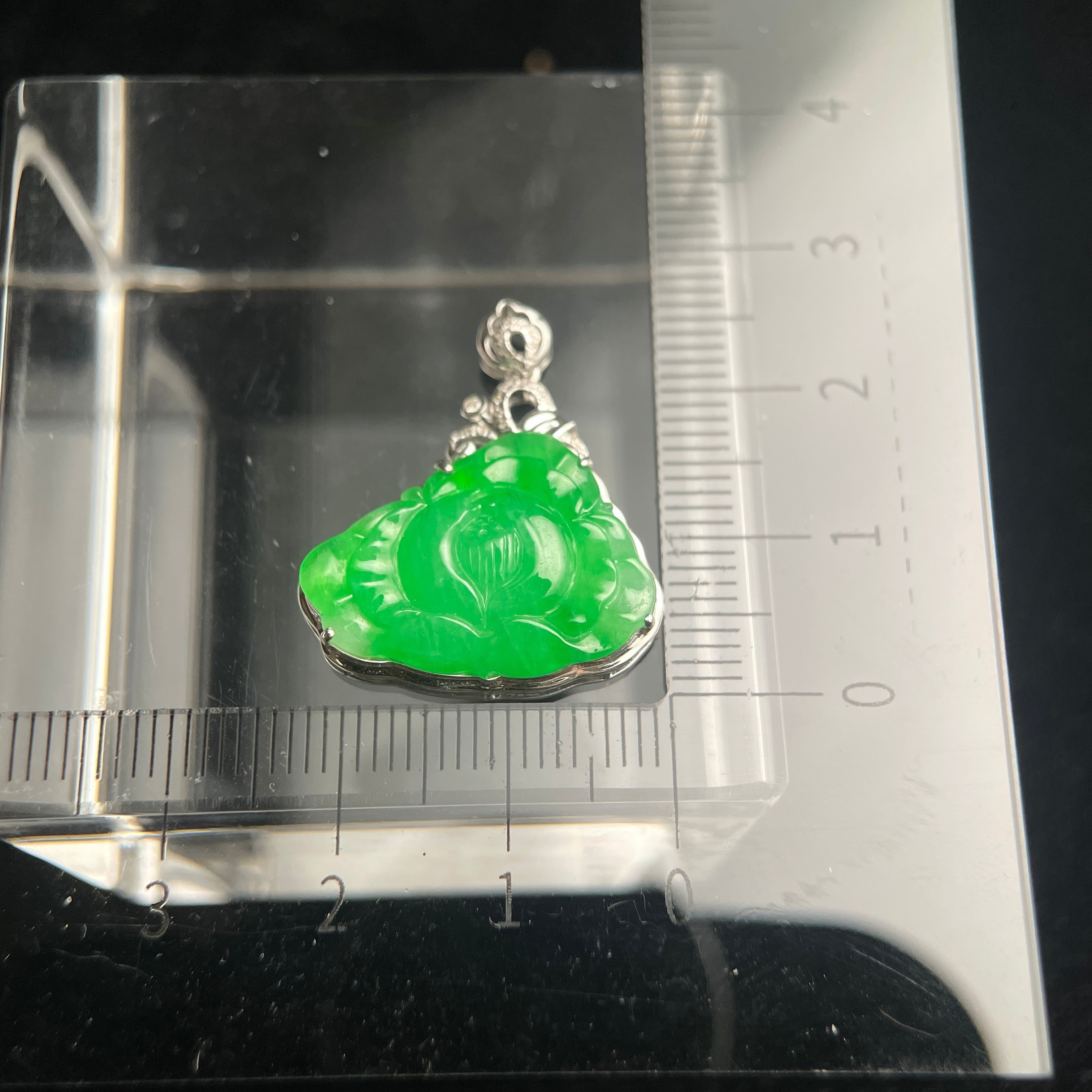 Sylvia Jewelry bright green jadeite jade lotus pendant hand-carved in polished 18K gold on a measuring scale.