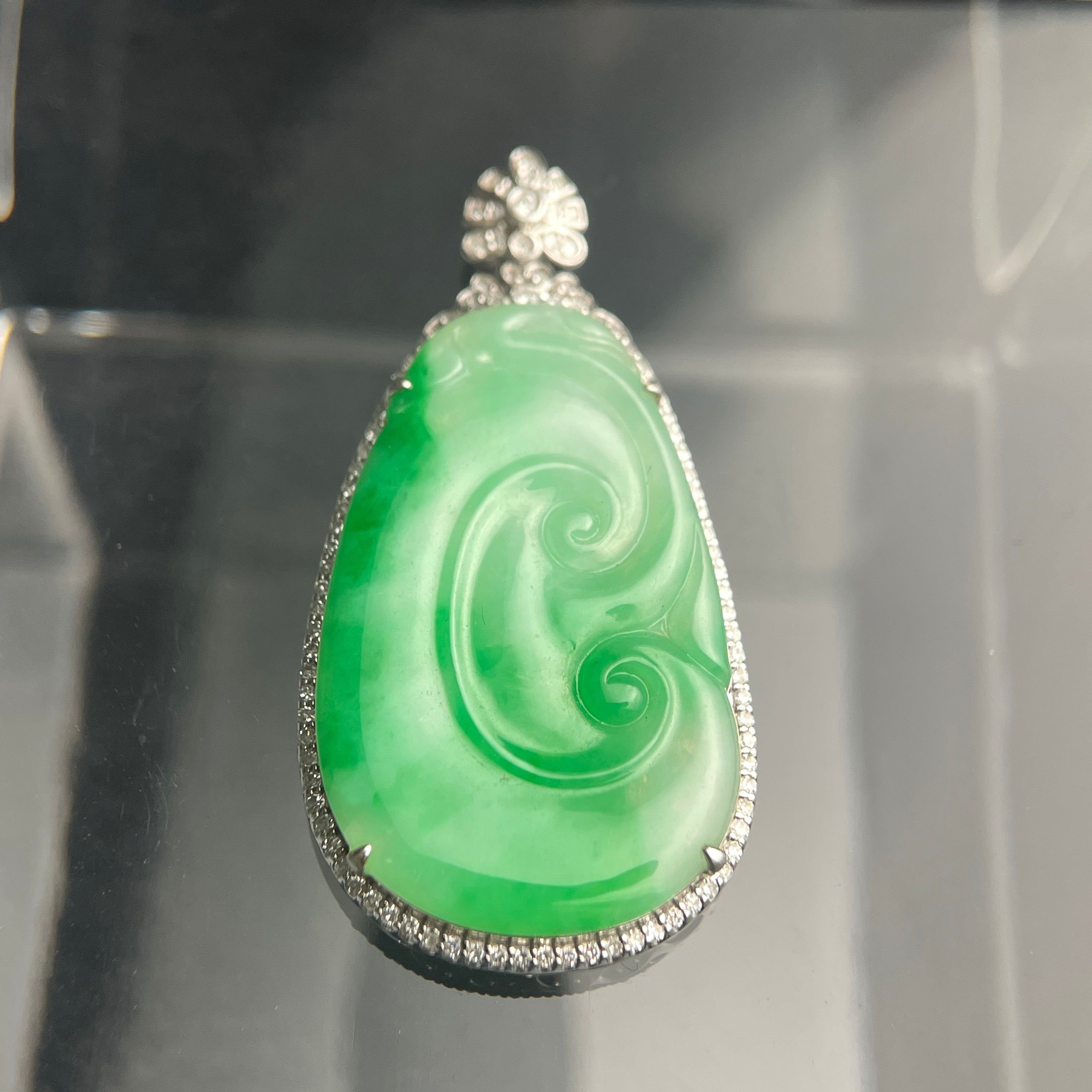 Sylvia Jewelry natural green Type A jadeite jade pendant with spiral carving and 18K gold diamond-accented setting.