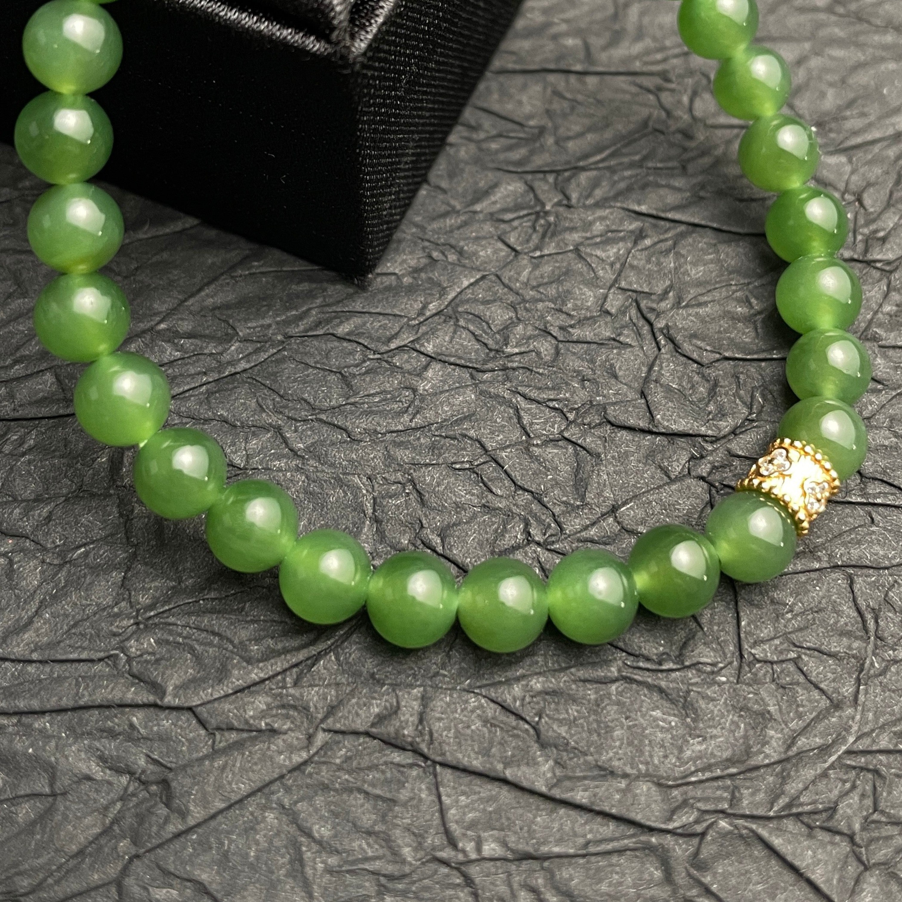 Sylvia Jewelry bracelet with natural green Hetian jade beads and a gold-plated silver accent bead with pavé detail.