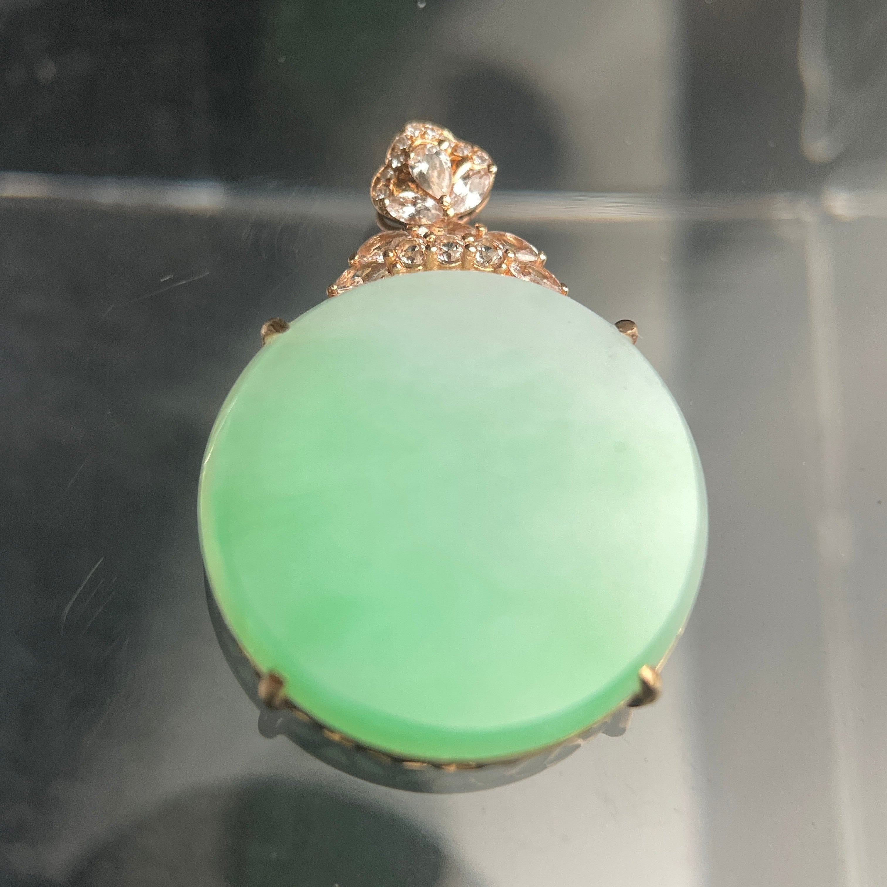 Sylvia Jewelry pale green jadeite oval pendant in 18K rose gold with a floral diamond-accented bail.