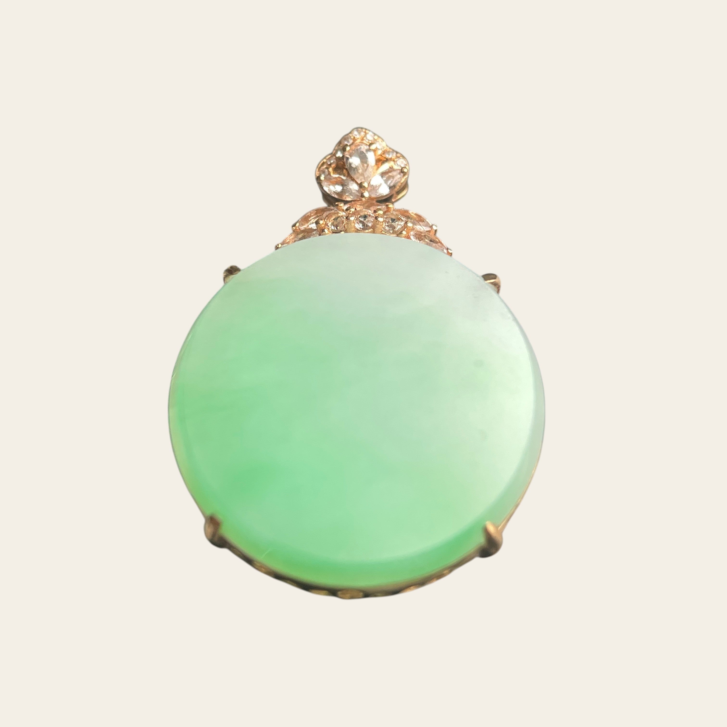 Sylvia Jewelry oval jadeite pendant in 18K rose gold with a diamond-accented floral bail on a pale green stone.