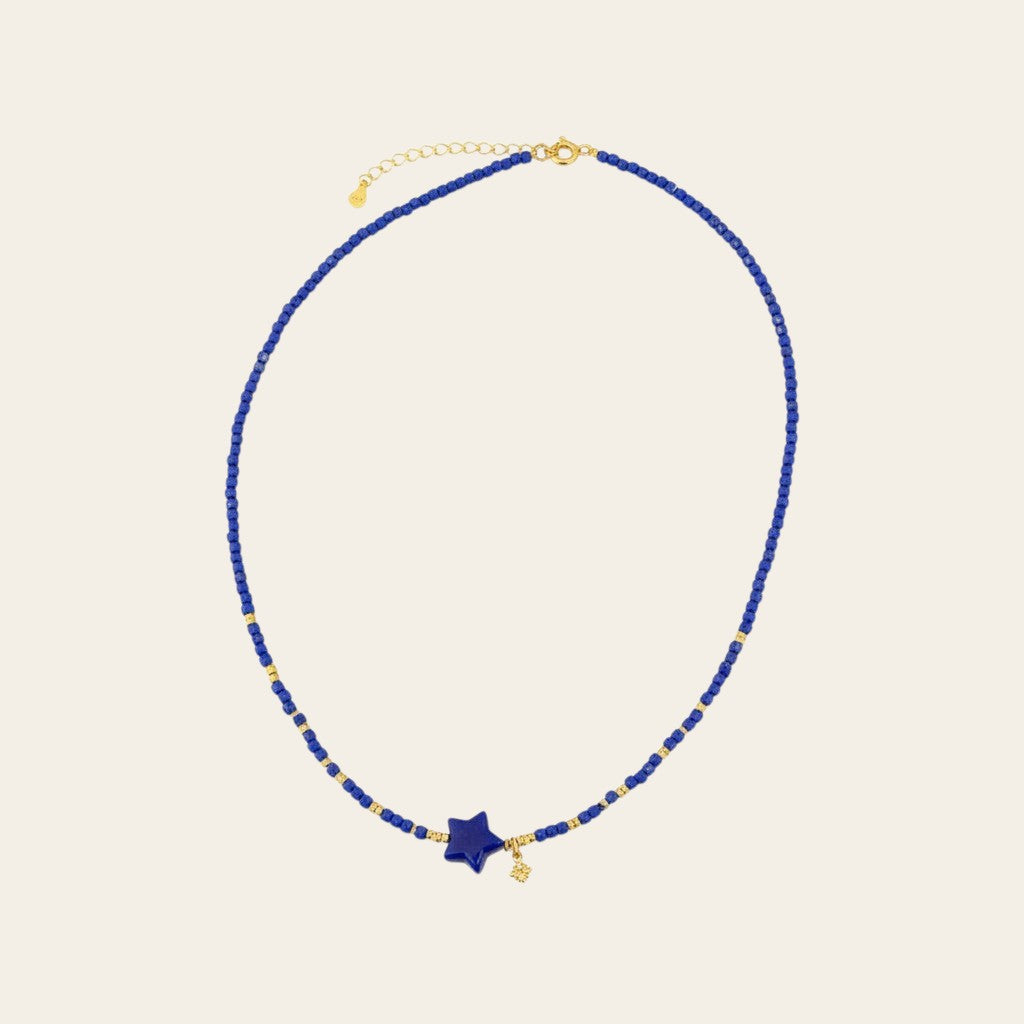 Sylvia Jewelry Celestial Night lapis lazuli beaded choker with a gold-plated star pendant and dangling charm.