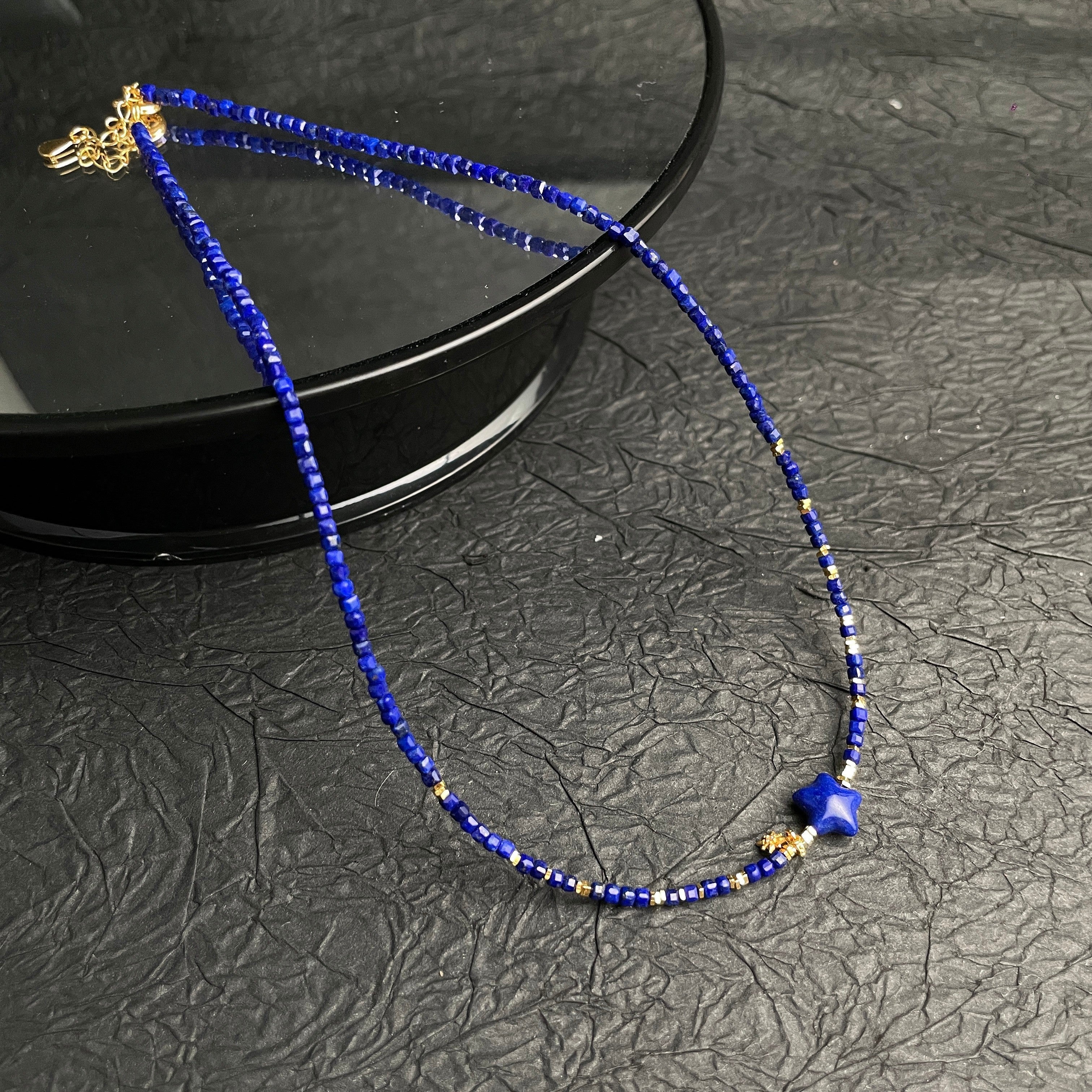 Sylvia Jewelry Celestial Night lapis lazuli beaded choker with a gold-plated star charm and sterling silver accents.