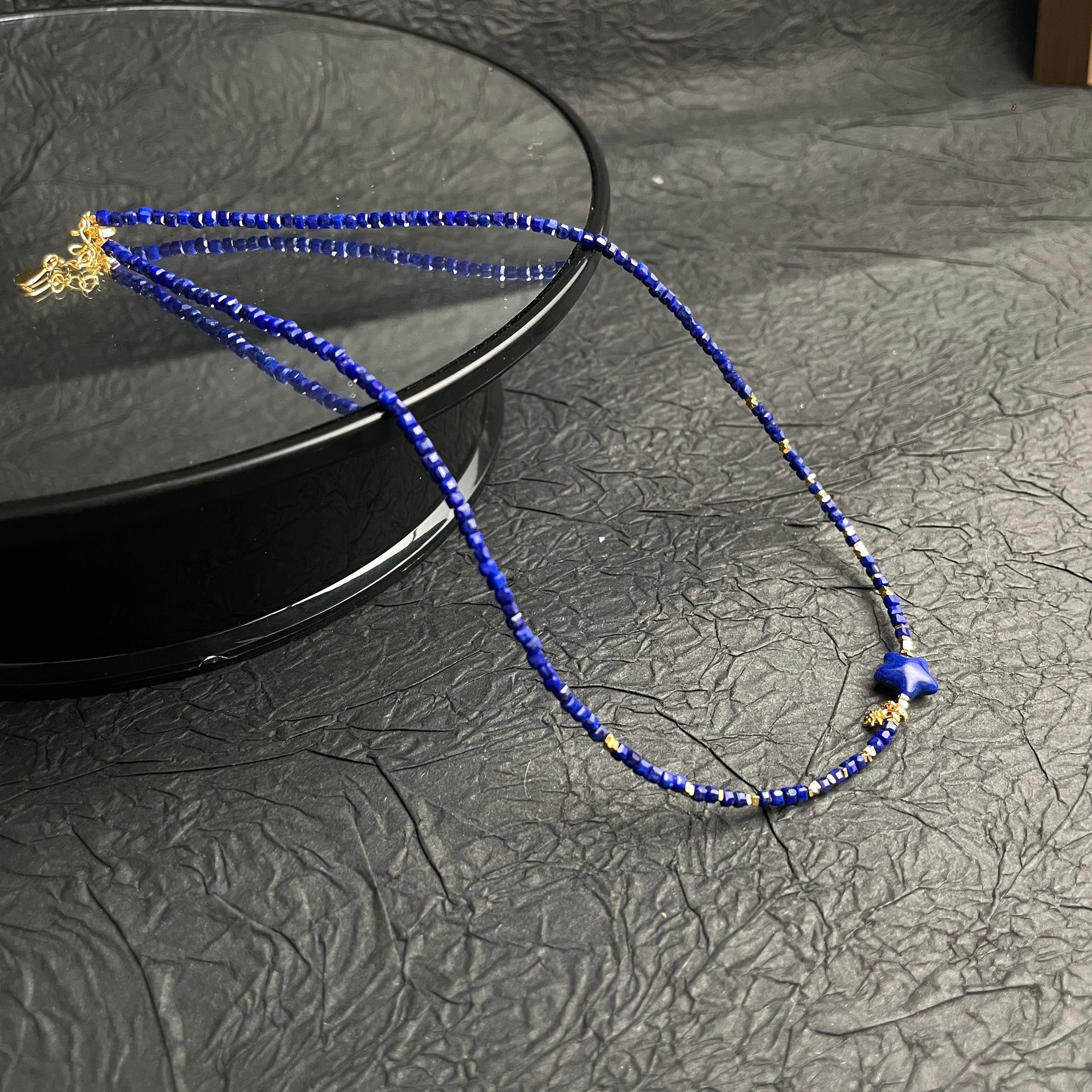 Sylvia Jewelry Celestial Night lapis lazuli beaded choker with gold-plated silver star charm and spacer beads.
