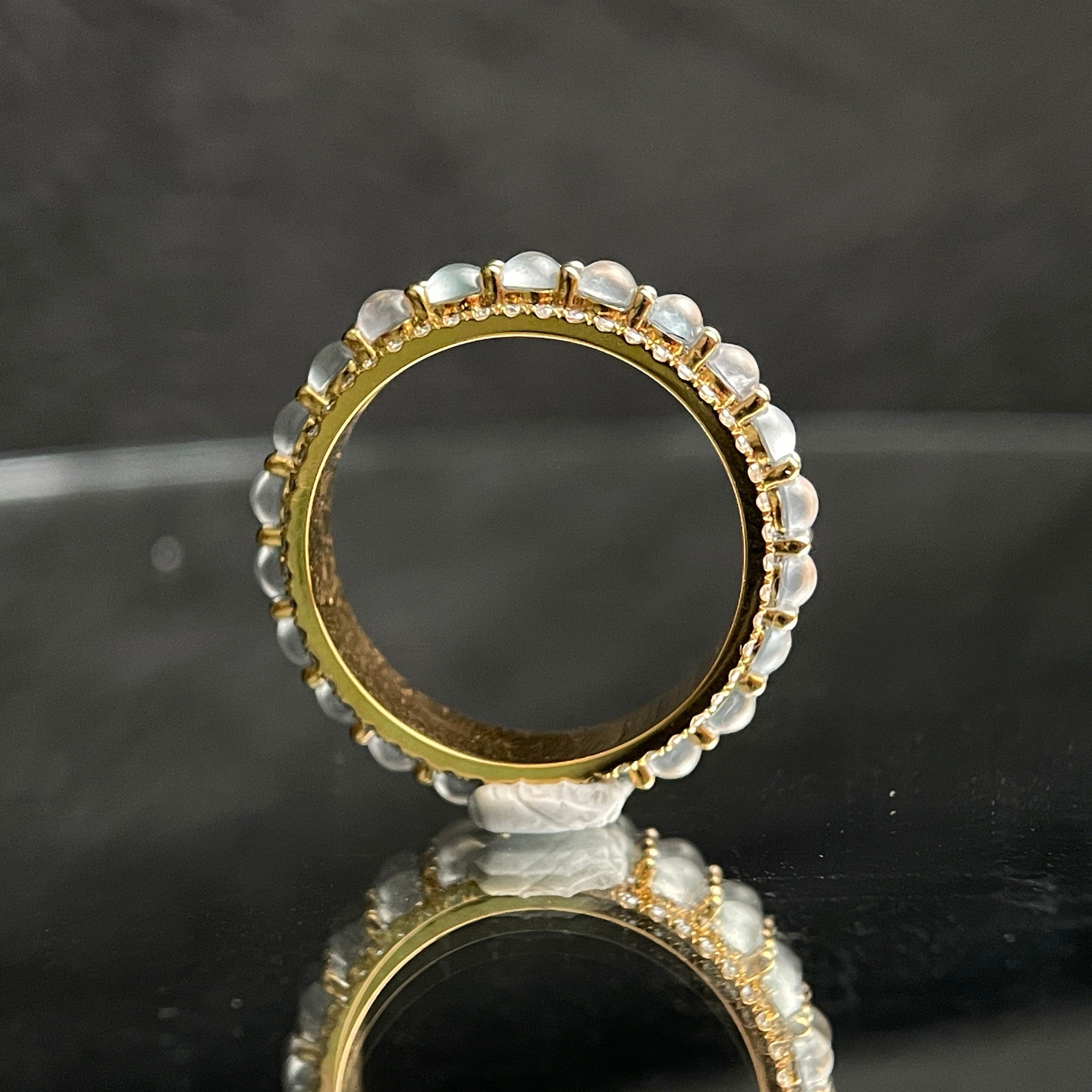 Sylvia Jewelry 18K gold ring with rotating white jadeite cabochons, smooth and translucent.