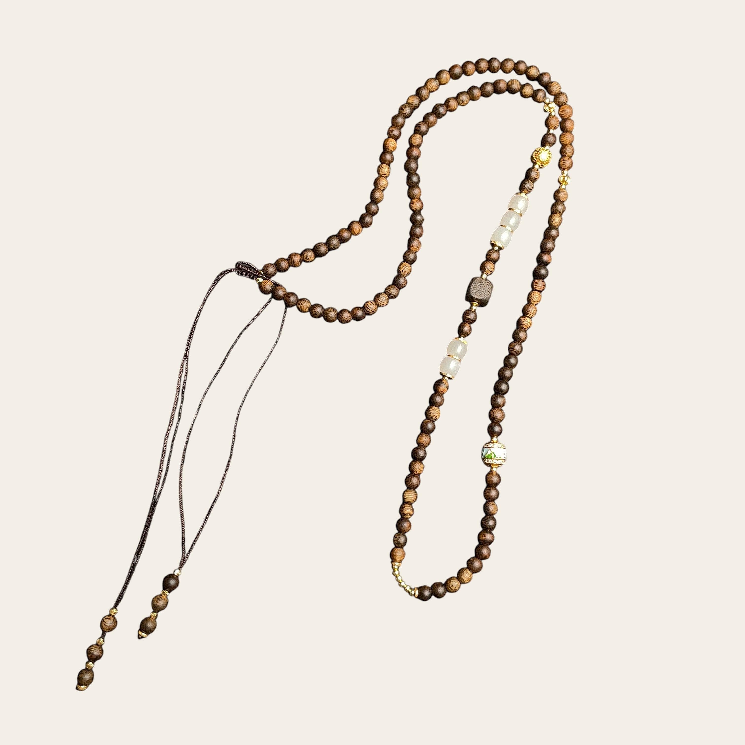 Sylvia Jewelry long wooden bead necklace with white stone accents and decorative gold-toned metal spacers