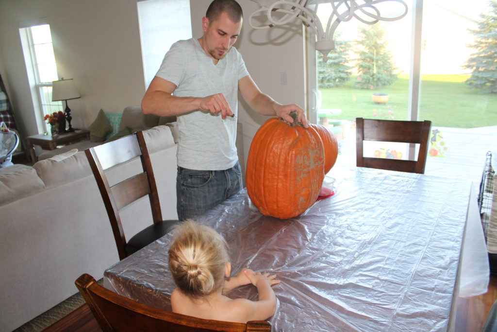 Daddy carving pumpkins
