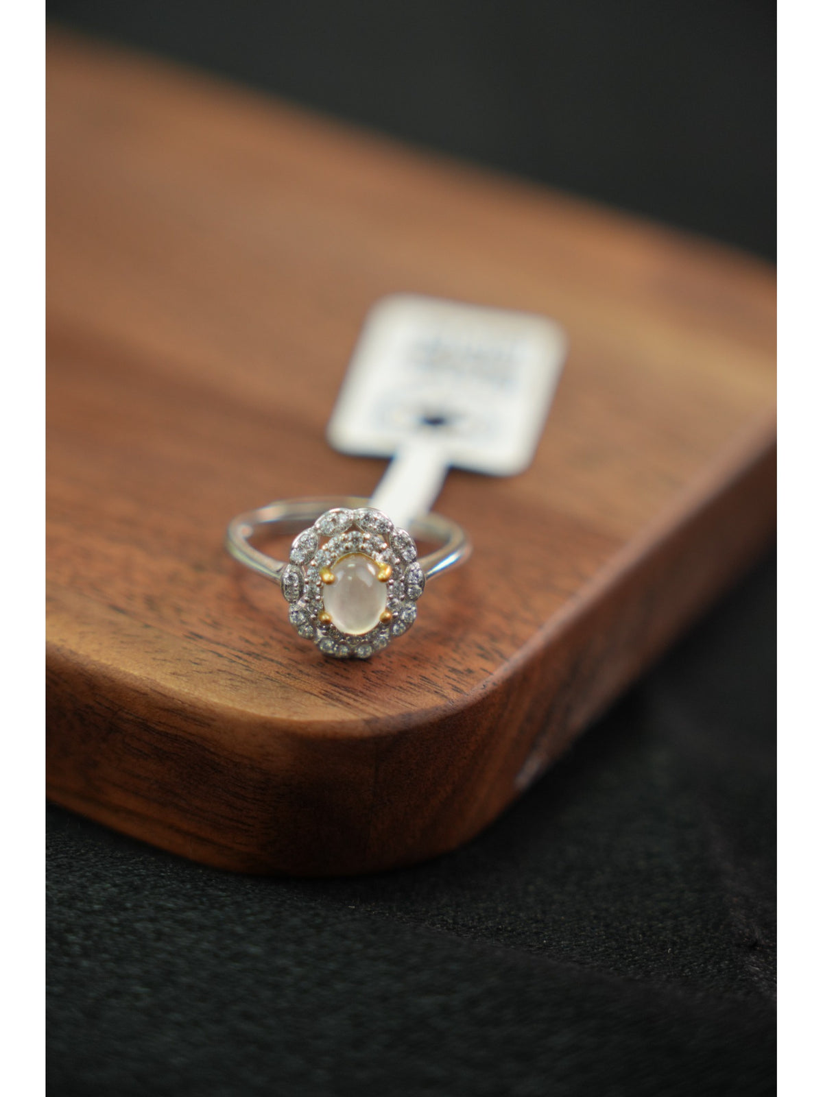 Pale jadeite halo ring in silver setting