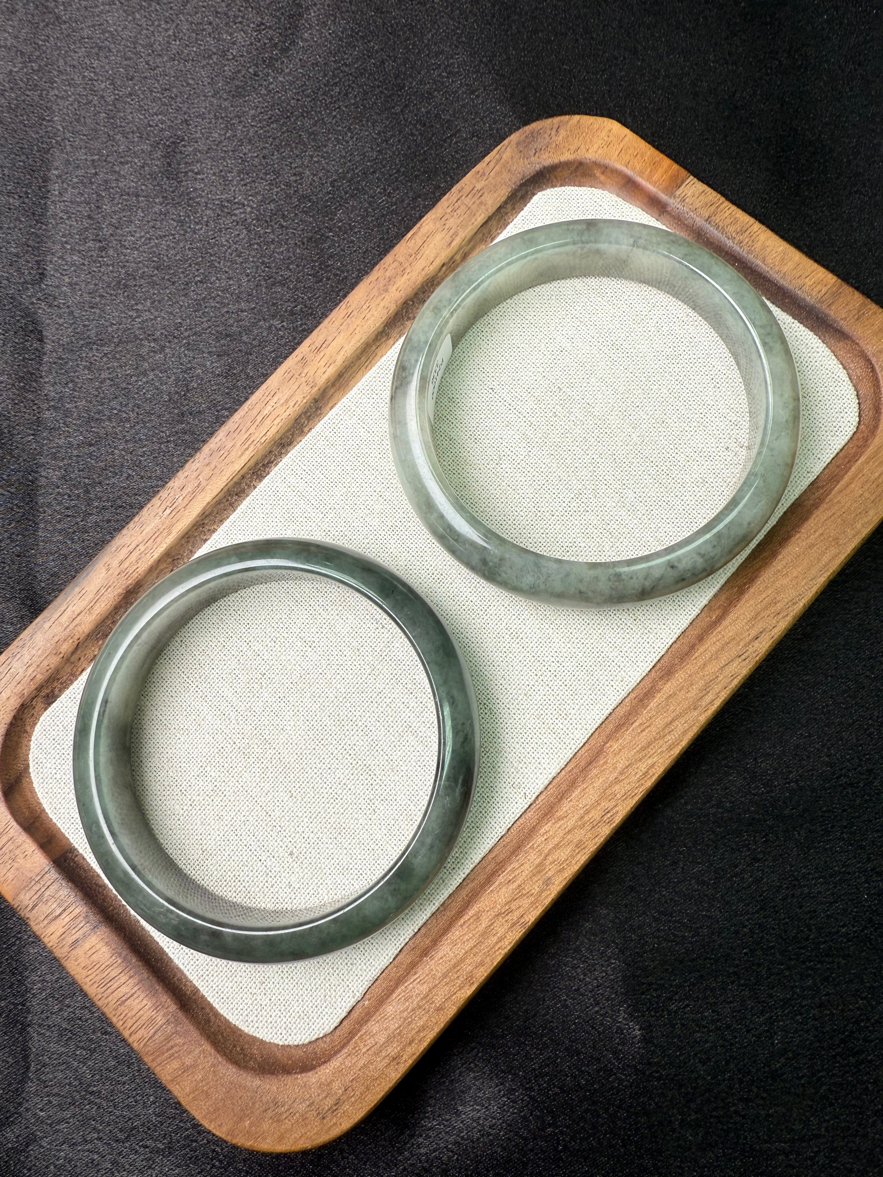 Two Black Wujin Jadeite（黑乌鸡翡翠）on a wooden tray with a black background