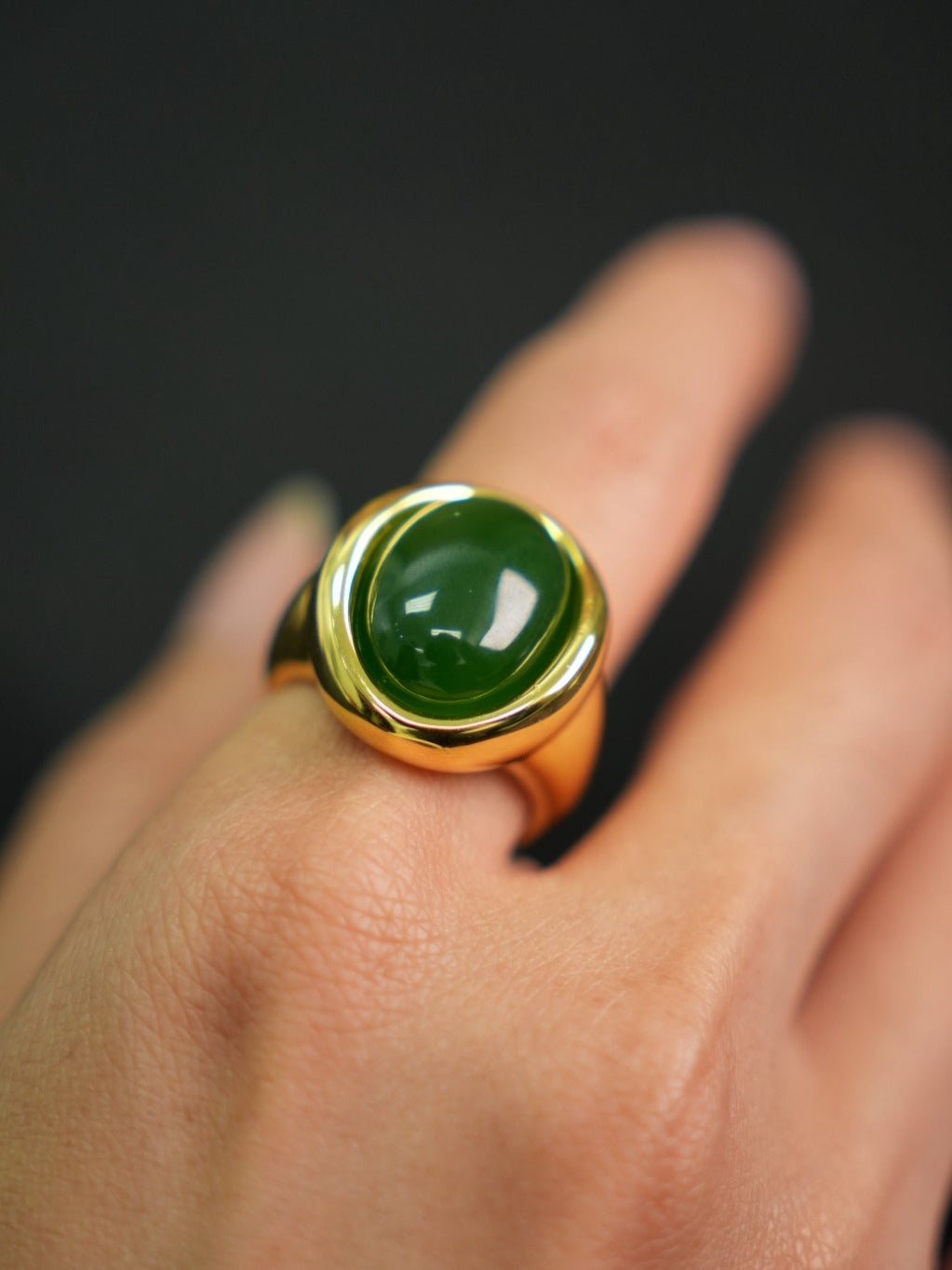 Green Hetian nephrite jade ring in a silver setting with a gold-tone appearance