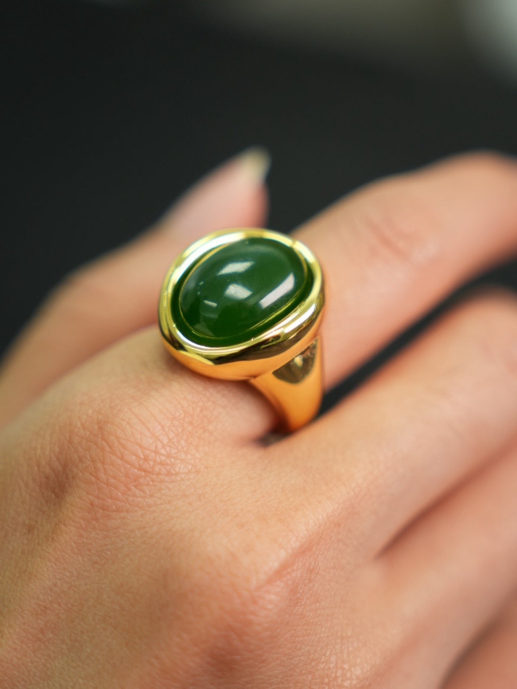 Green Hetian nephrite jade ring in a silver setting with a gold-tone appearance