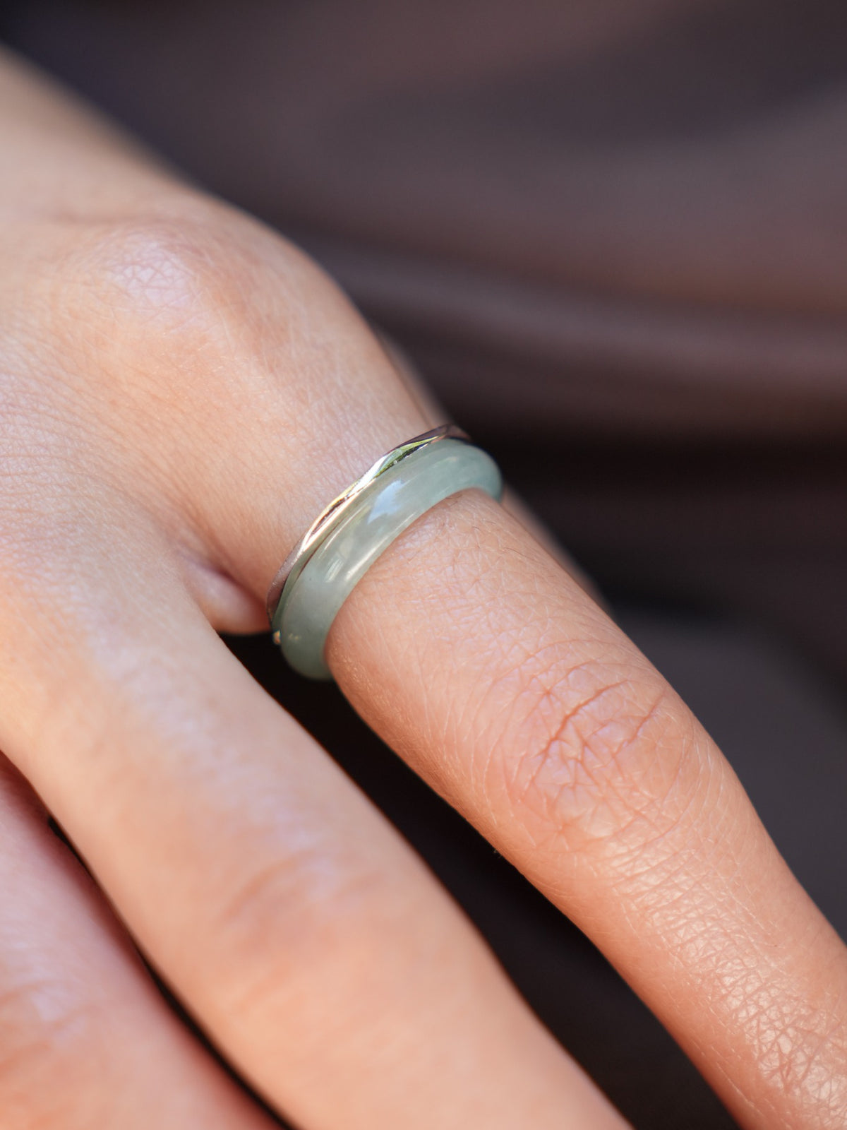 Green jadeite band rings — worn on hand, detail and styling view