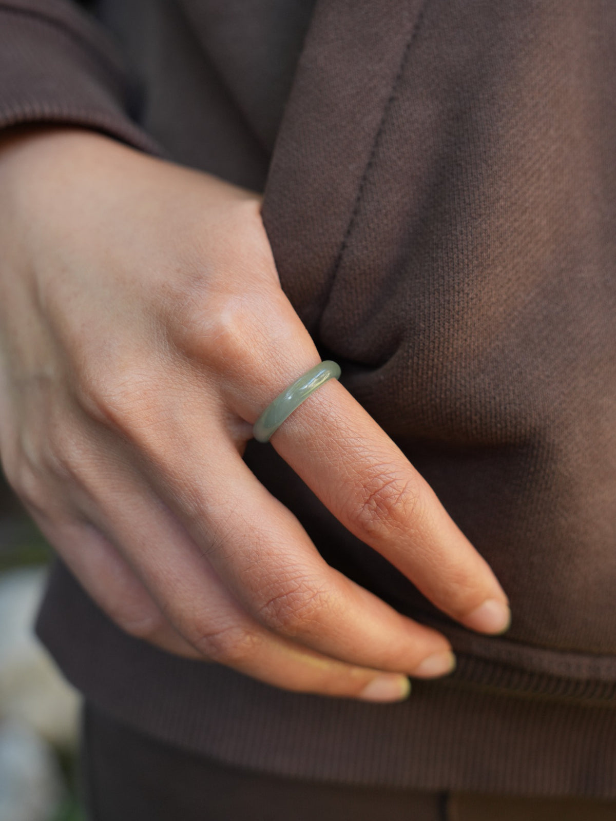 Green jadeite band rings — worn on hand, detail and styling view