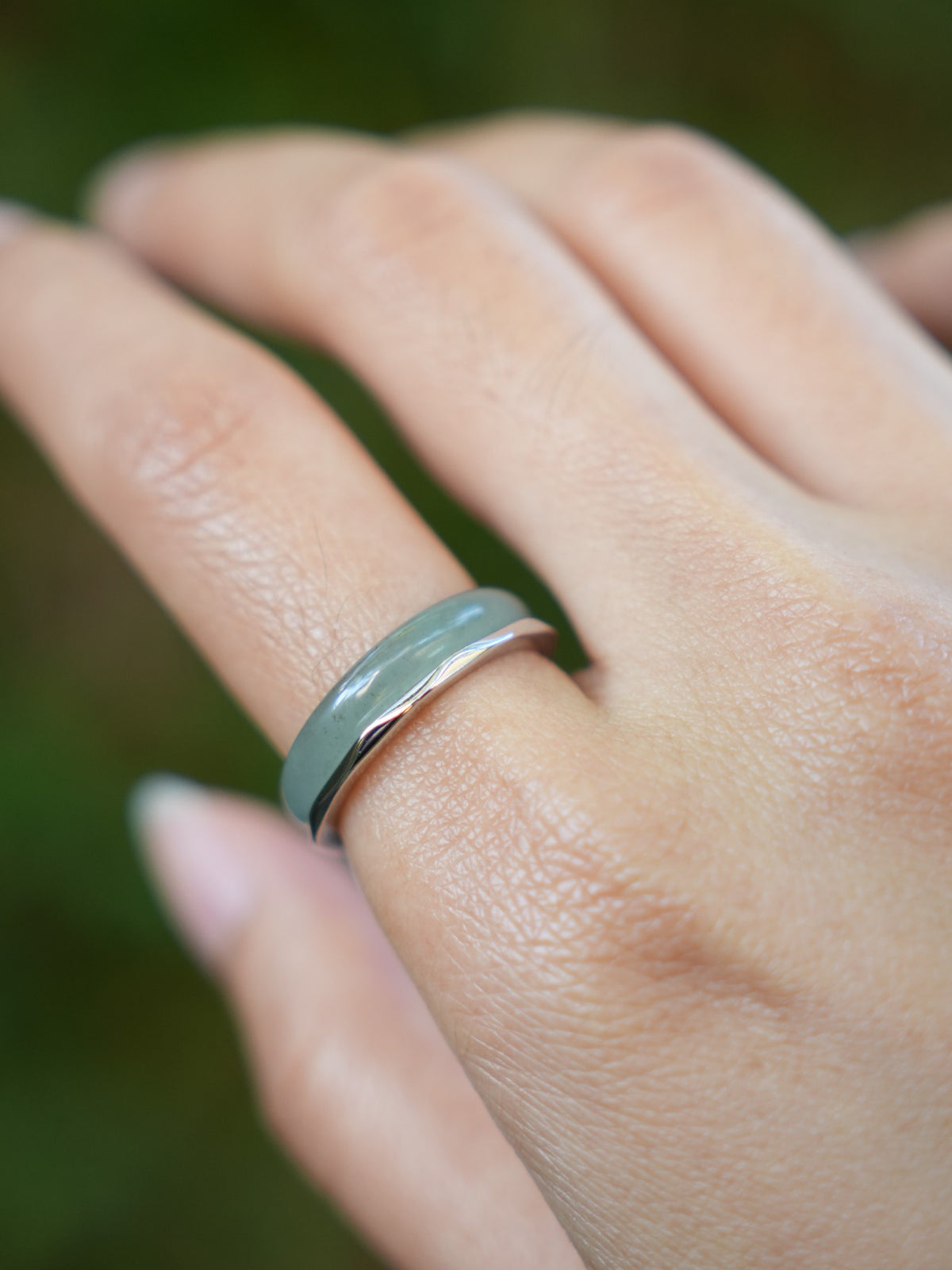 Green jadeite band rings — worn on hand, detail and styling view