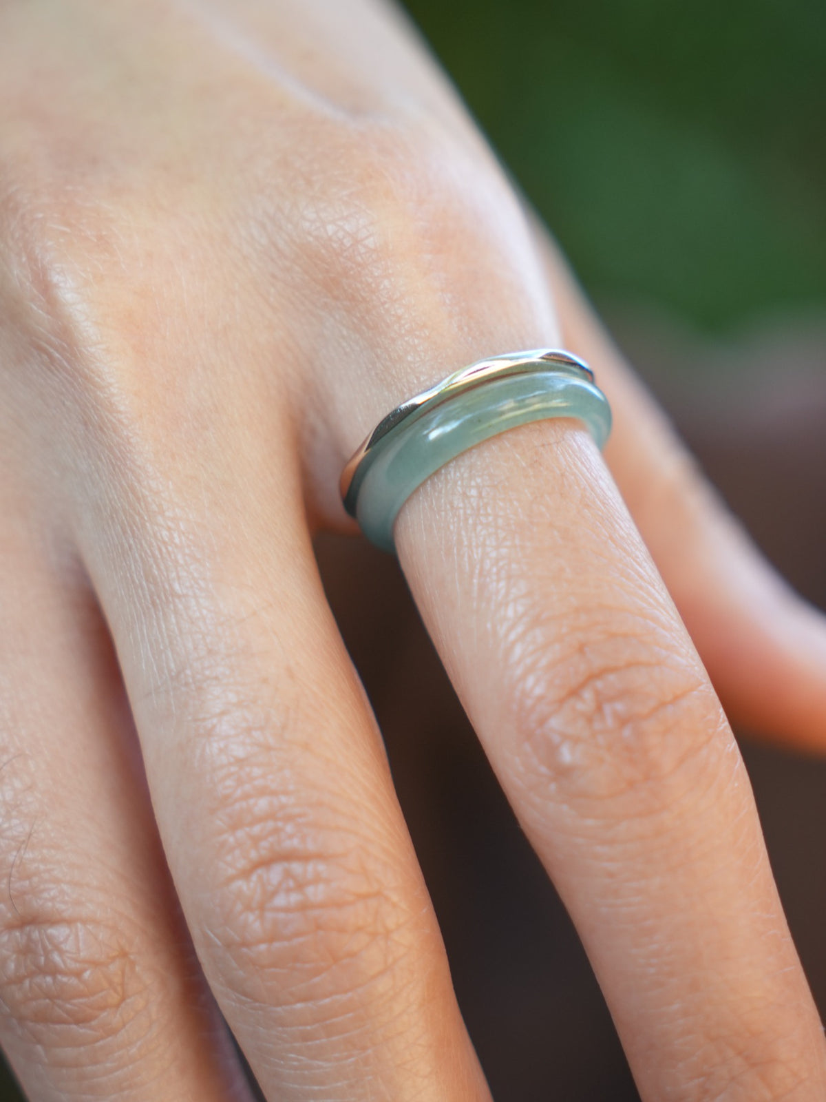 Green jadeite band rings — worn on hand, detail and styling view