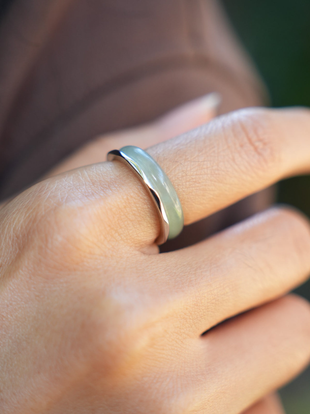 Green jadeite band rings — worn on hand, detail and styling view