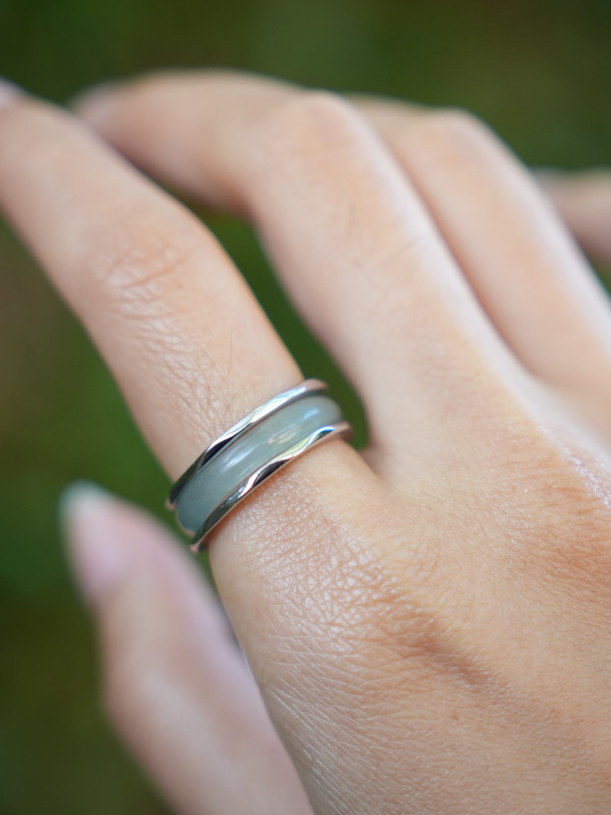 Green jadeite band rings — worn on hand, detail and styling view