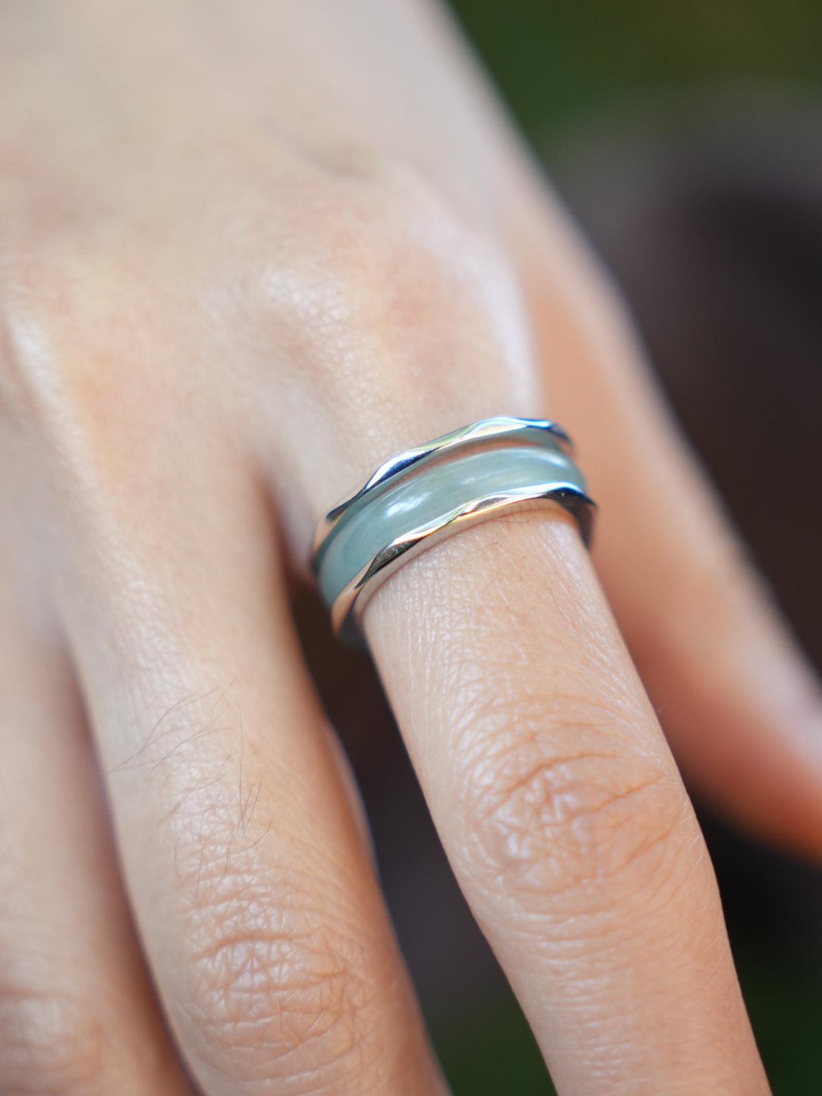 Green jadeite band rings — worn on hand, detail and styling view