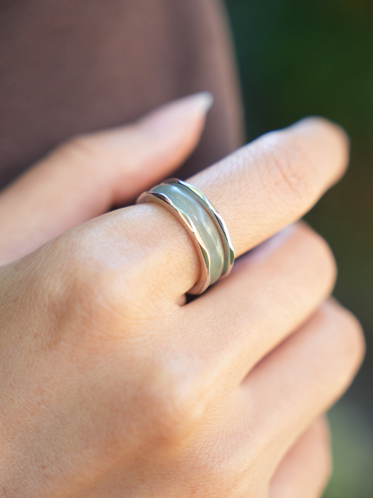 Green jadeite band rings — worn on hand, detail and styling view