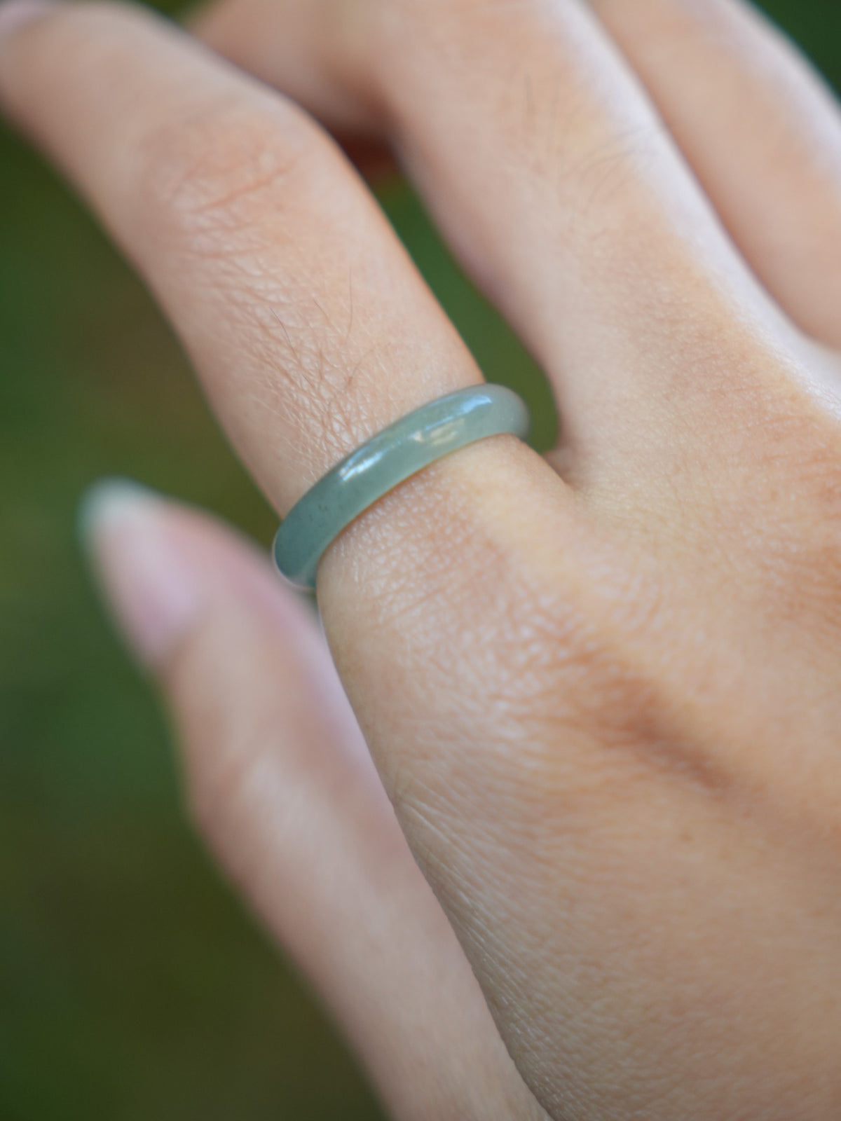 Green jadeite band rings — worn on hand, detail and styling view