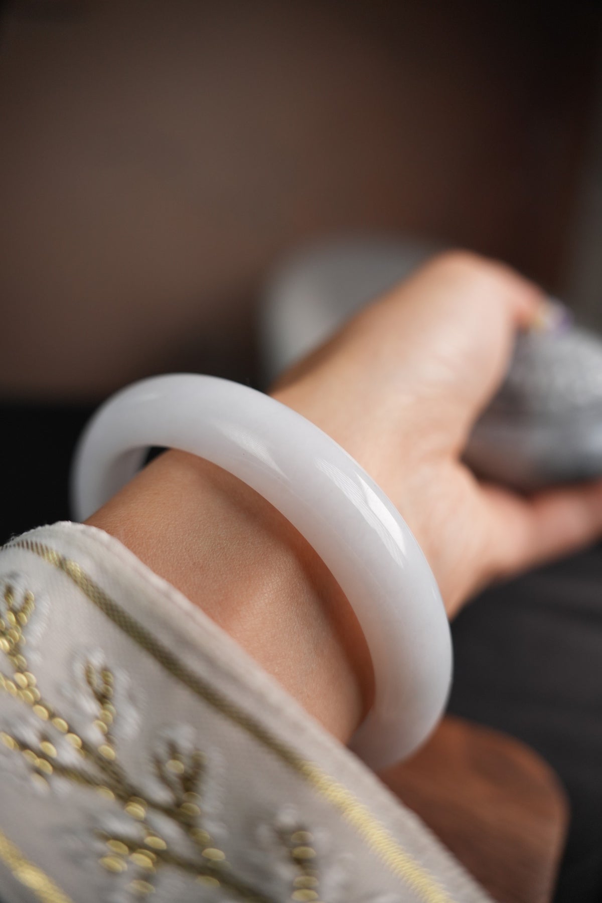 60 mm Type A jadeite bangle with pale green and lavender tones, actual piece P2509005811, worn on wrist