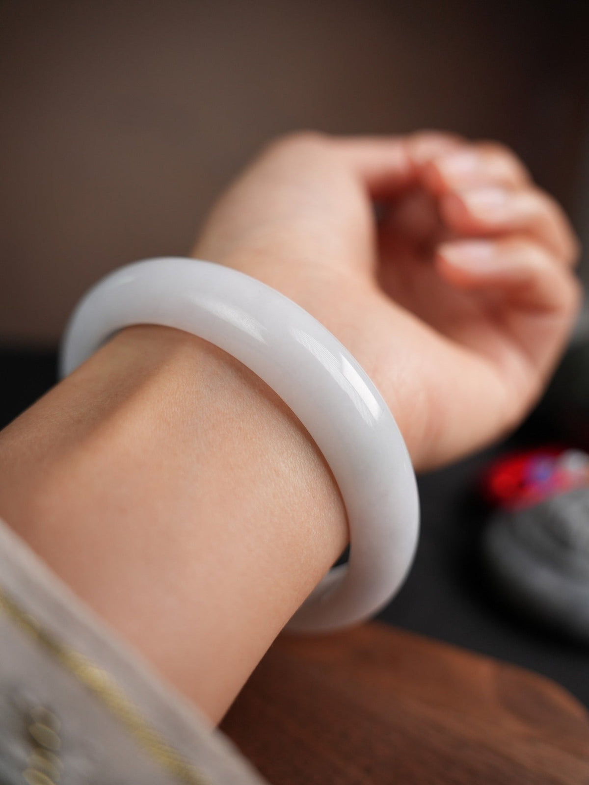 60 mm Type A jadeite bangle with pale green and lavender tones, actual piece P2509005811, worn on wrist