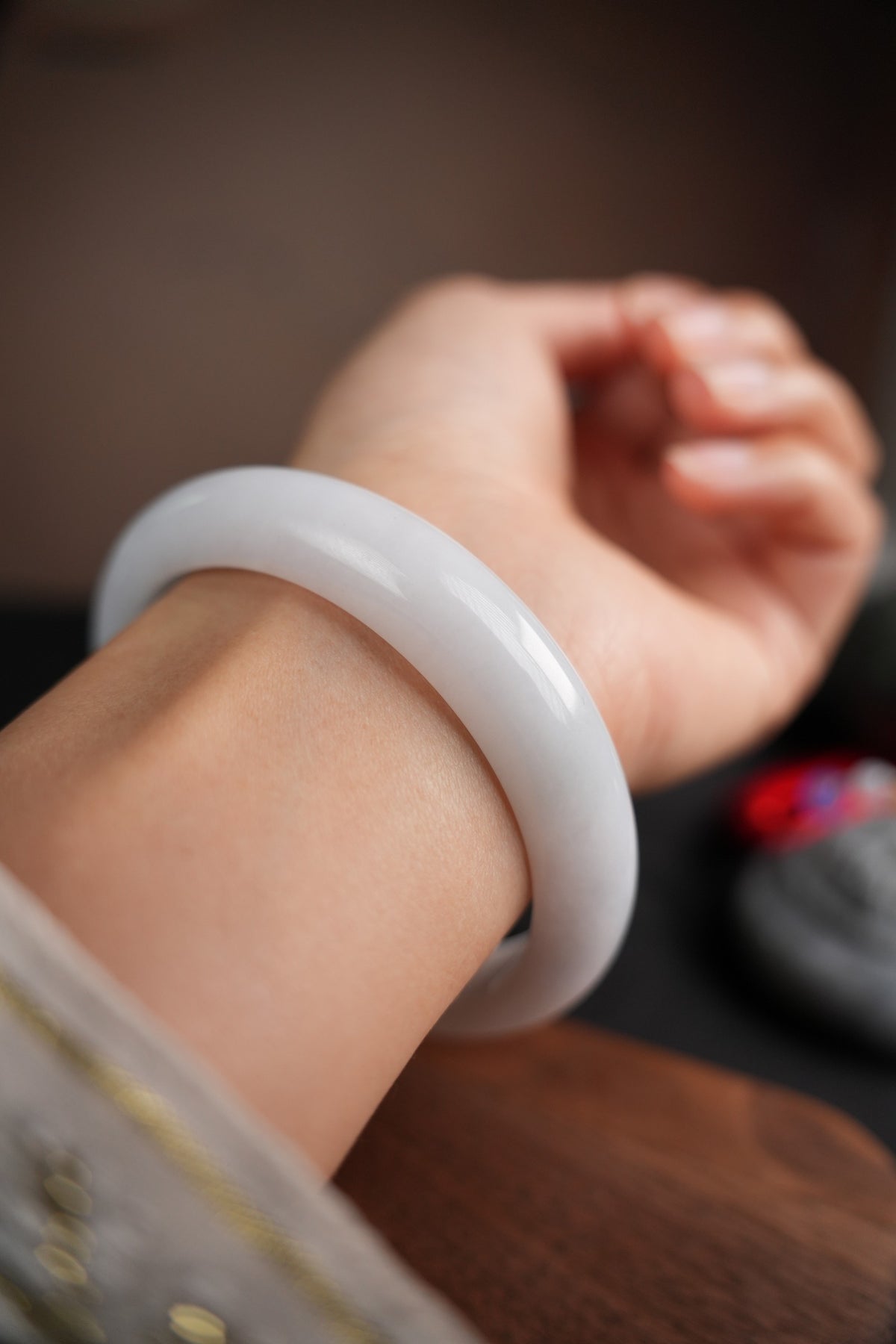 60 mm Type A jadeite bangle with pale green and lavender tones, actual piece P2509005811, worn on wrist