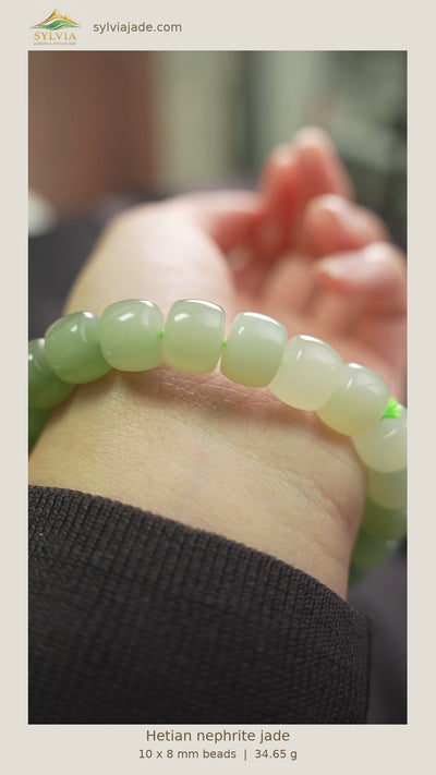 Green gradient Hetian nephrite jade barrel-bead bracelet XJZZ26092801535; full original frame with warm ivory border, company logo, website and English product details