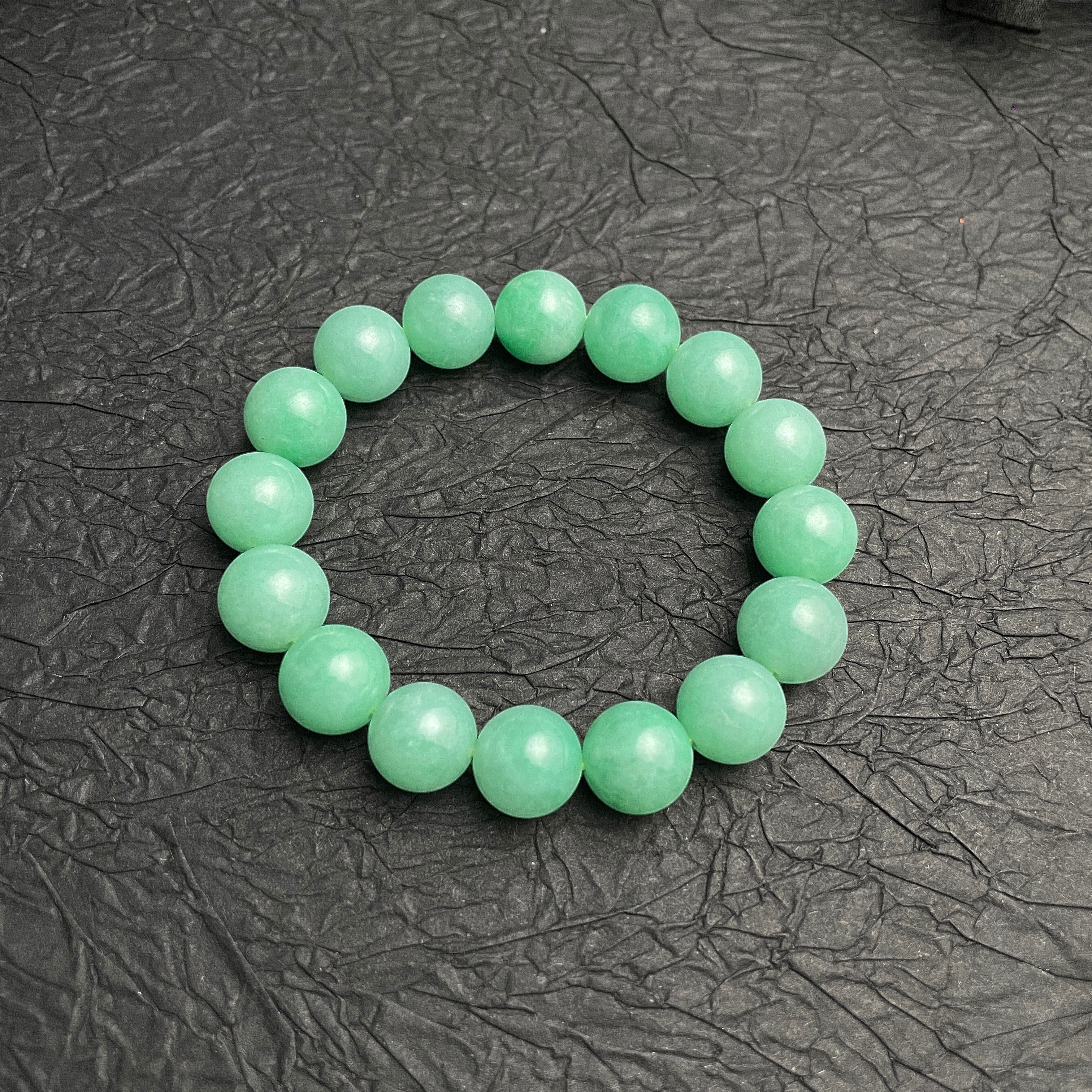 Sylvia Jewelry 14mm smooth green jadeite bead bracelet with natural luster, ideal for daily wear.
