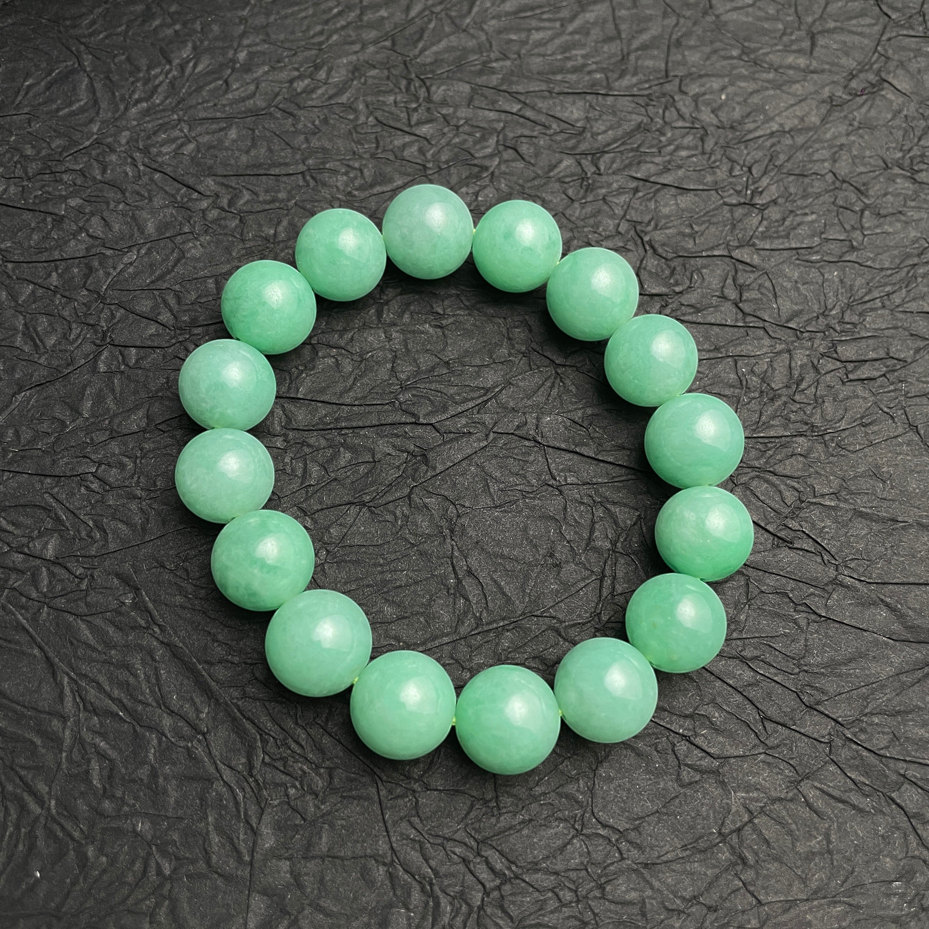 Sylvia Jewelry 14mm smooth green jadeite bead bracelet with natural luster, ideal for daily wear.